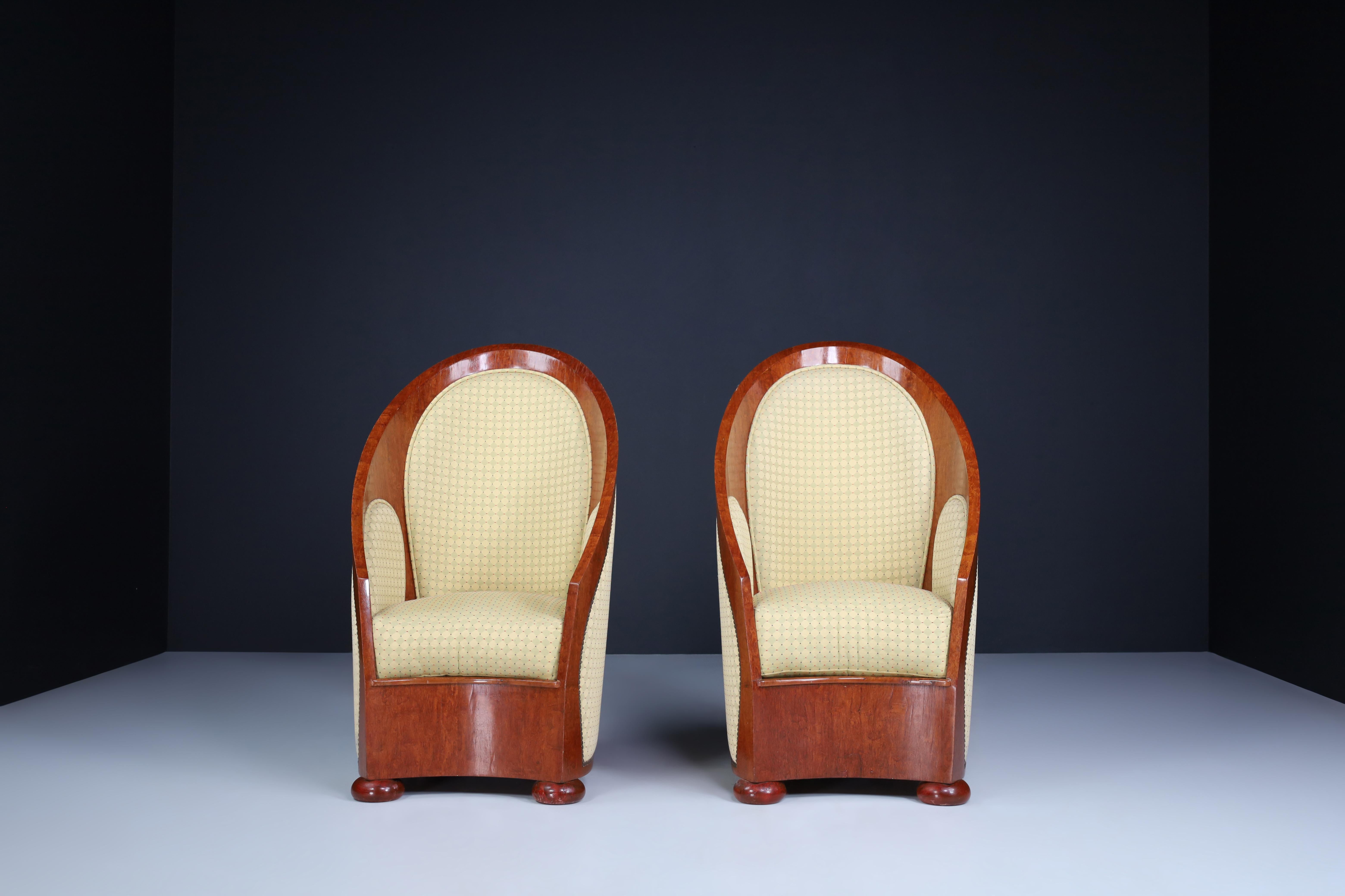 Art Deco armchairs in walnut and original upholstery, Italy, 1930s. 

Art Deco armchairs in walnut and original upholstery, Italy, 1930s. These exceptional lounge chairs would make an eye-catching addition to any interior, such as a living room,