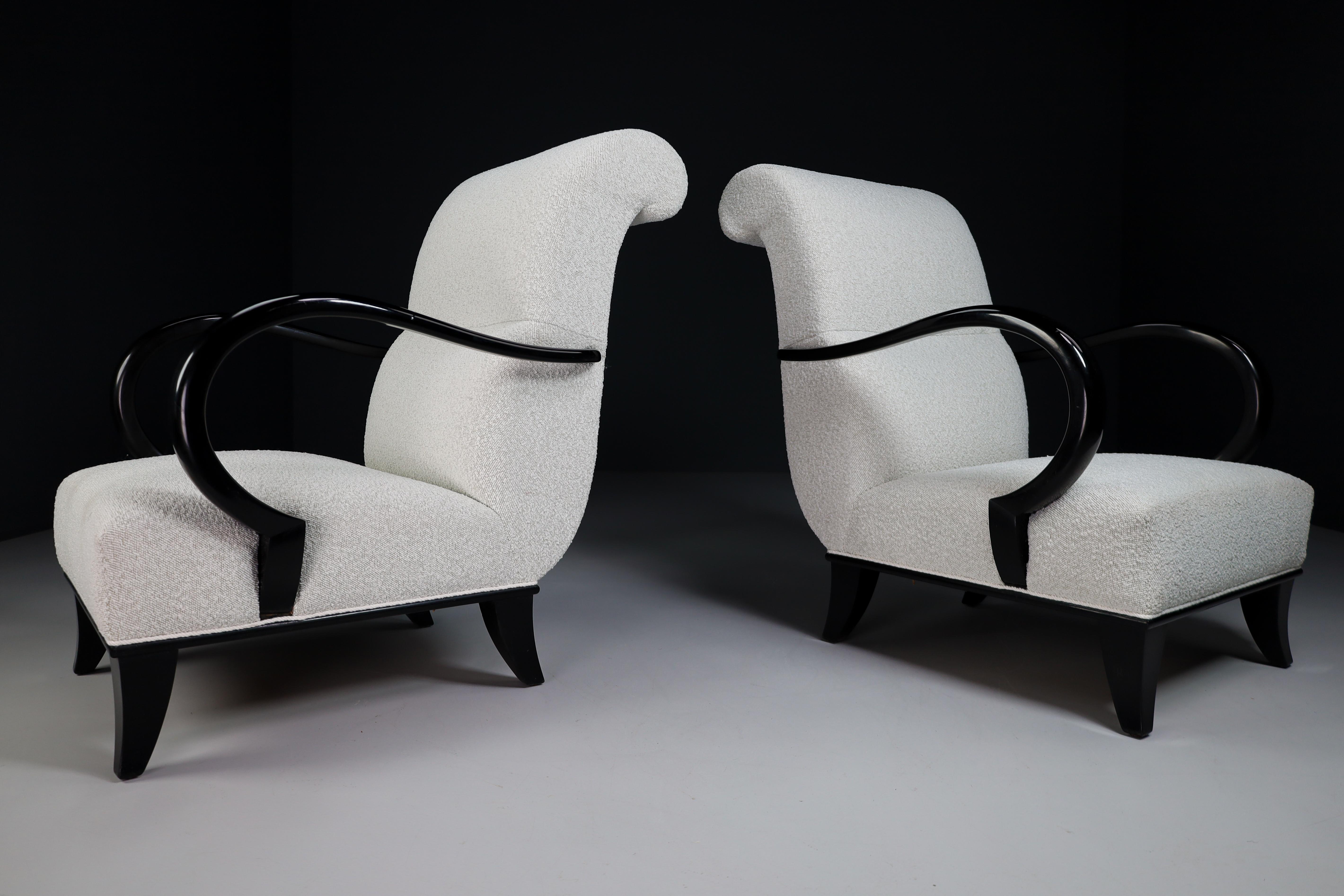 Pair of two elegant Art-Deco armchairs or lounge chairs manufactured and designed in Vienna 1930s. Made of hardwood and professionally reupholstered in bouclé wool fabric. These armchairs would make an eye-catching addition to any interior such as