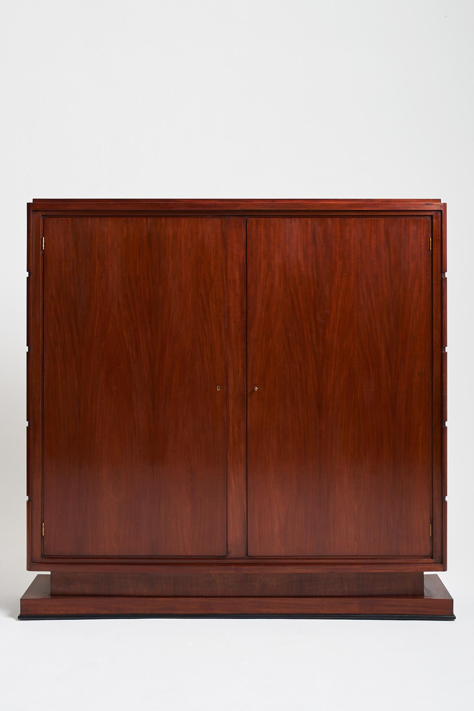 An Art Deco armoire (or bookcase) by Jean Rousseau & Pierre Lardin (1902-1981), the two wide doors revealing a fully blond oak lined interior, fitted with adjustable shelves and a safe, opening with two doors and itself fitted with internal