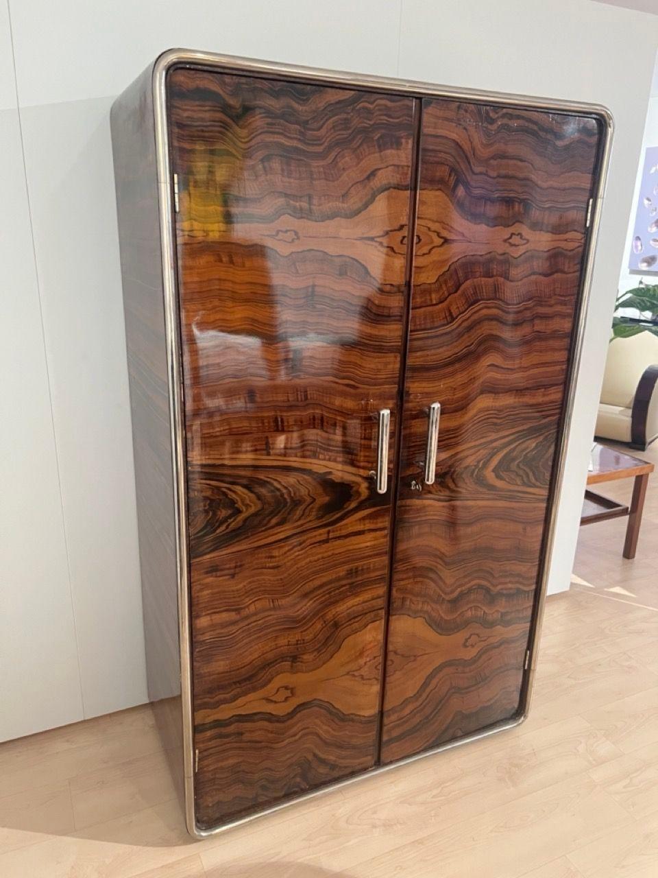 Original, extraordinary and rare Bauhaus / Art Deco wardrobe from Germany or Czech Republic around 1930.
Plywood painted in rosewood veneer look. At the front of the frame a circumferential, bid and polished tubular steel rod.
2 chrome-plated