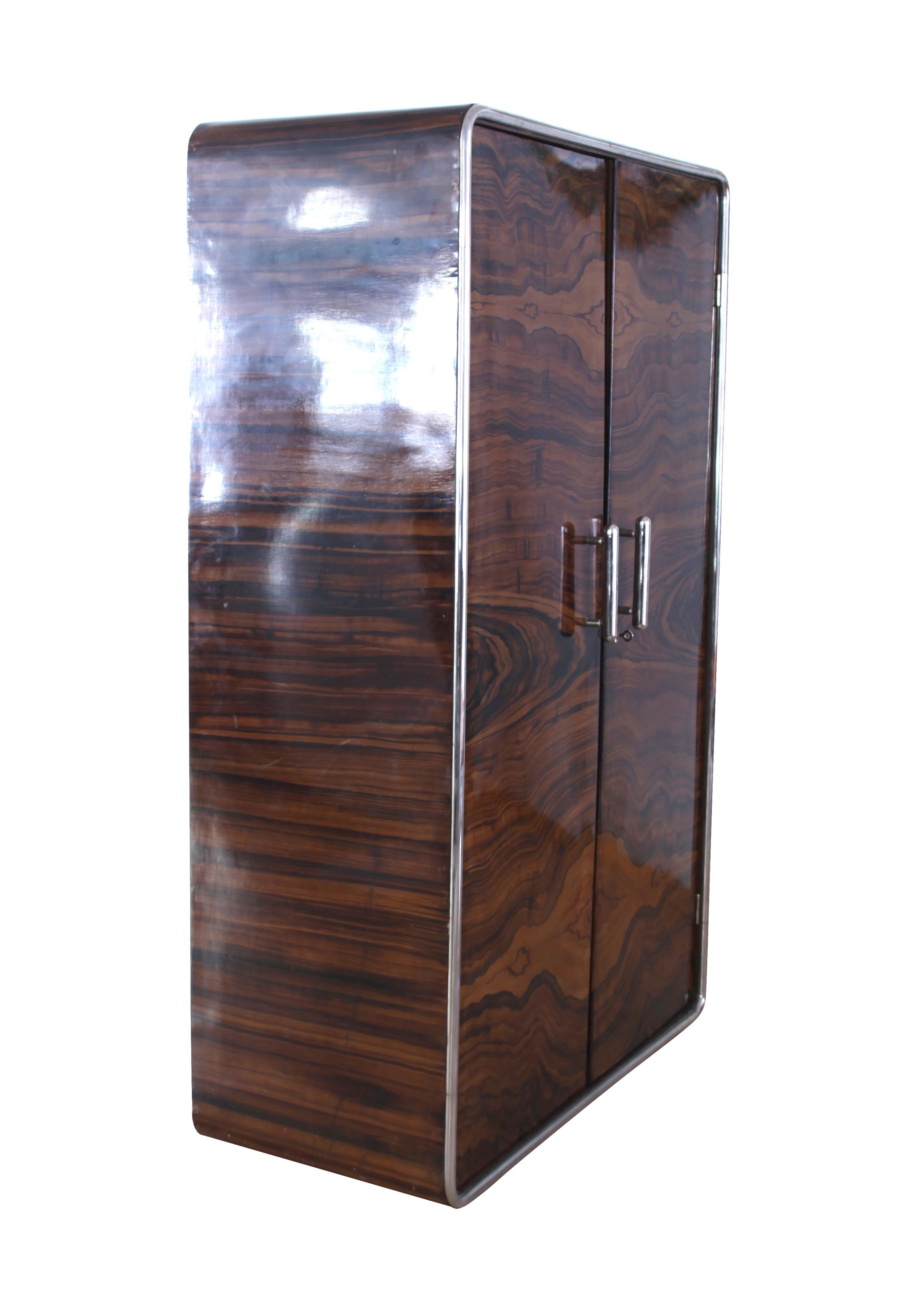 Elegant and unusual two-doored Art Deco Armoire from Czechia, circa 1930.

The wood is plywood (beech) painted in a wonderful bookmatched Palisander veneer optic, a quite rare technique from this period.

Around the whole edge of the trunk, there is