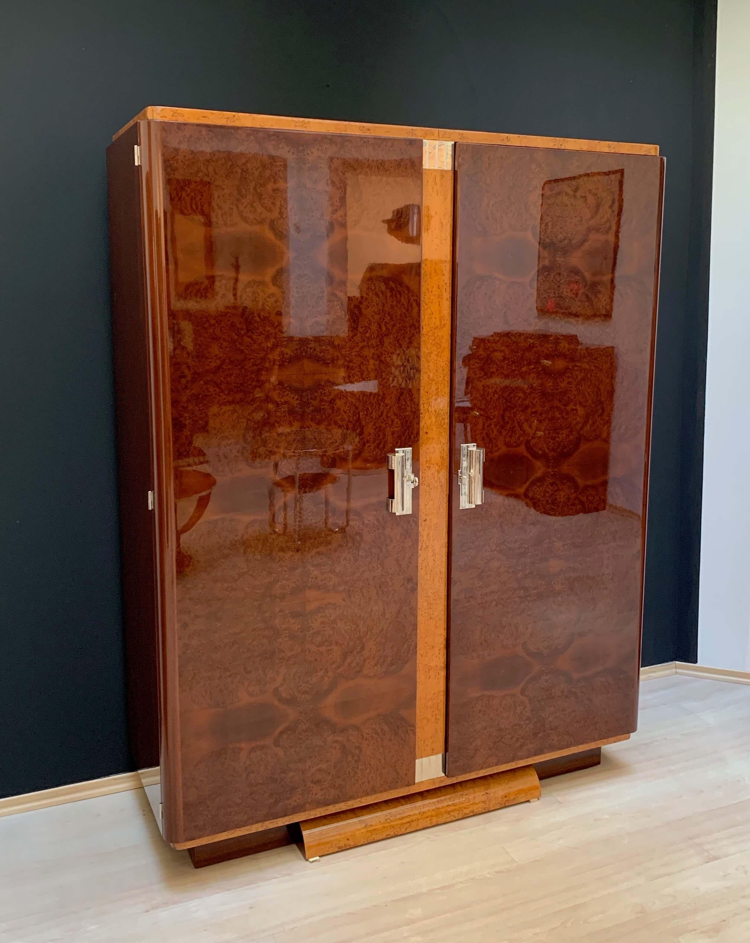 Fully restored original Art Deco Armoire or Wardrobe from France about 1925. 

Beautiful thuja burl / roots veneer on the doors and ice birch at the middle bar. Original nickel-plated handles and silver-plated ornaments. Inside with 4 adjustable