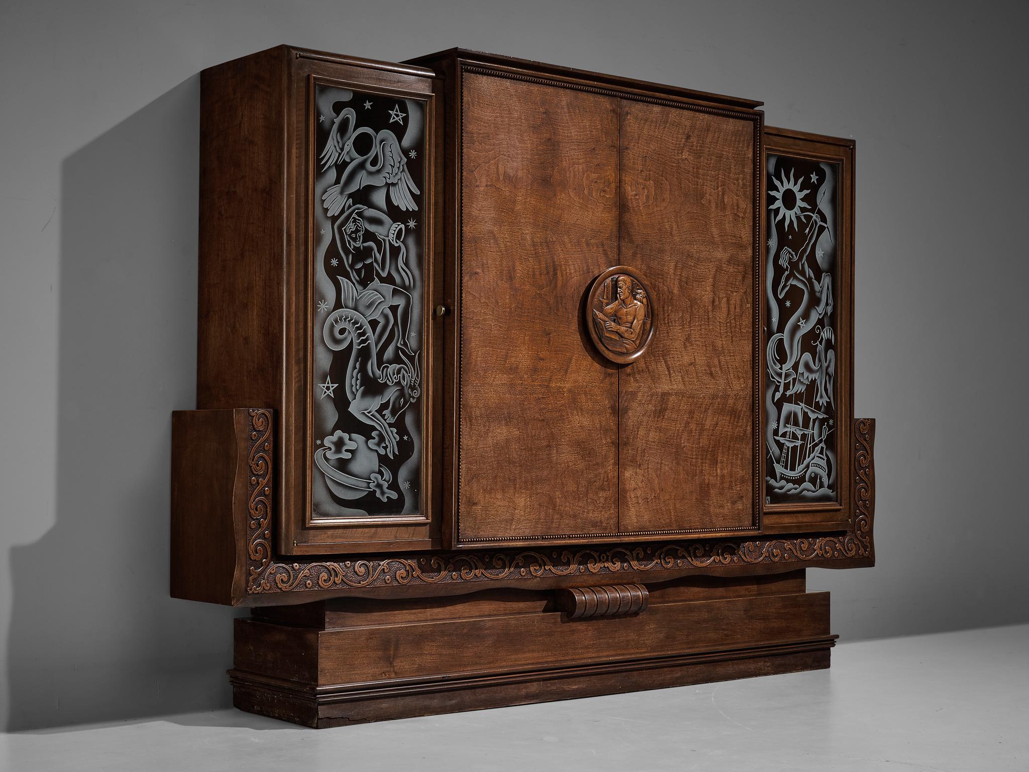 Armoire, walnut, glass, France, 1930s 

This exceptional armoire undoubtedly breathes the Art Deco Period of the 1930s. The design convinces visually through its grotesque execution of ornamental arrangements on the glass panels featuring