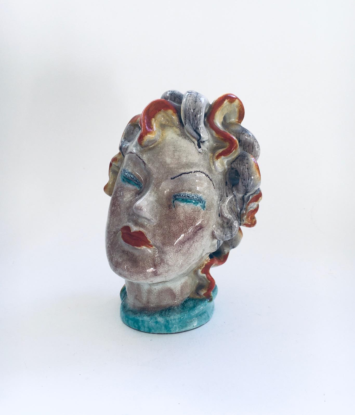 Vintage Art Deco Art Ceramics Woman Buste Figure in the style of Goldscheider. Made in the 1930's. Austria or Italy. Multi colored glazed woman head with luscious curled hair. A rare art ceramic figure. Comes in very good condition. Measures 20cm x