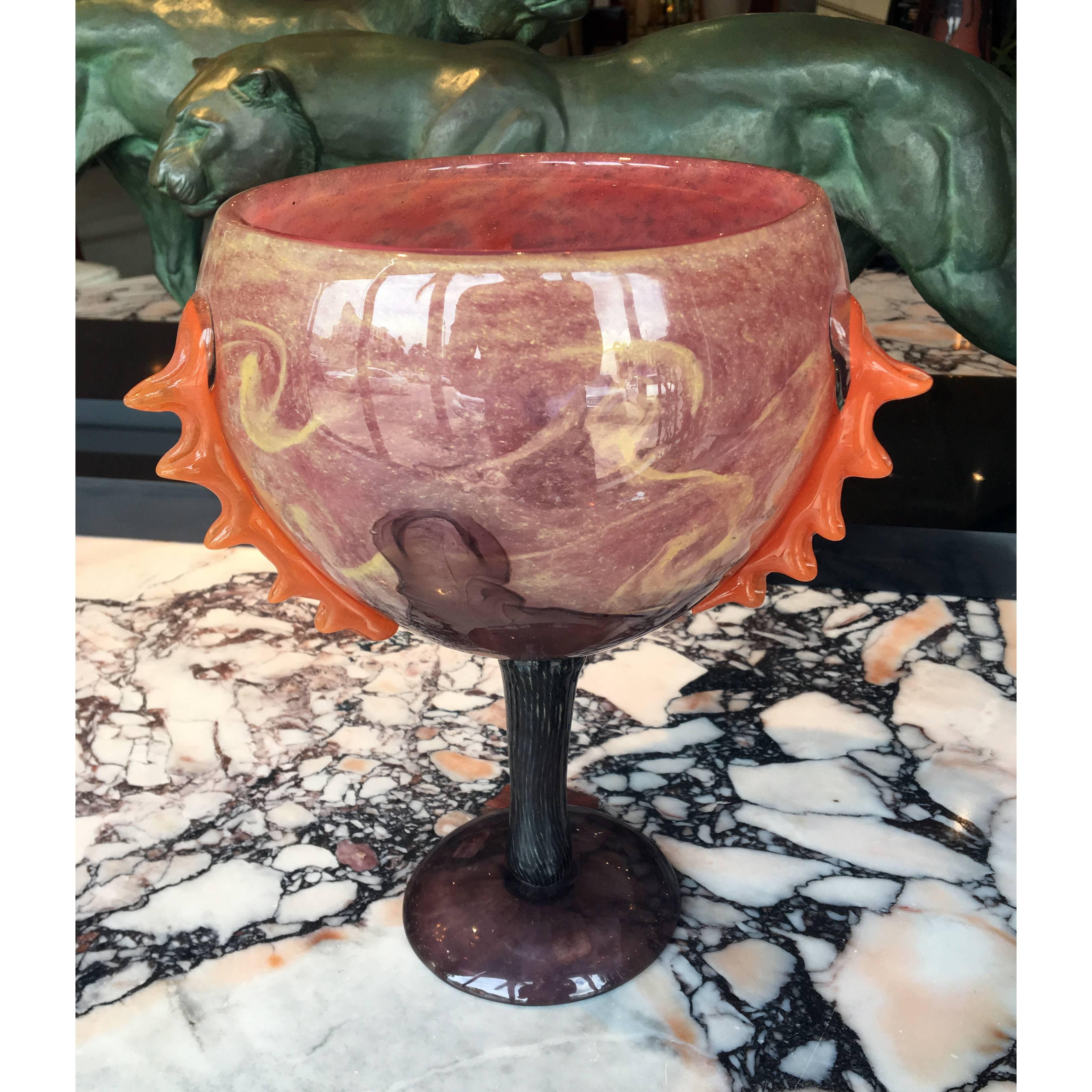 Art Deco glass tazza by Charles Schneider with purple and pink colored glass, with scallops of orange-powdered glass along the body.
Made in France
circa 1922
Signature: Schneider.