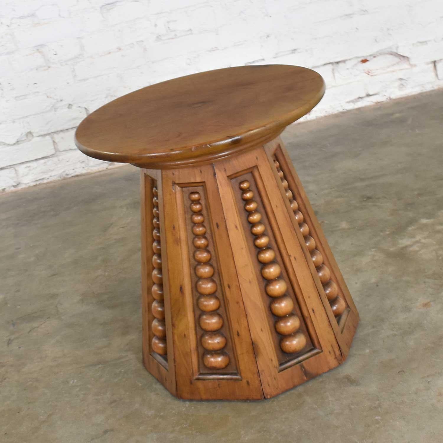 Handsome and amazing teak side table with a round top and conical octagon base with carved orbs. Not sure if it is Art Deco, Art Nouveau, or Arts & Craft in style. It is in fabulous antique condition. That does not mean it is without flaws or signs