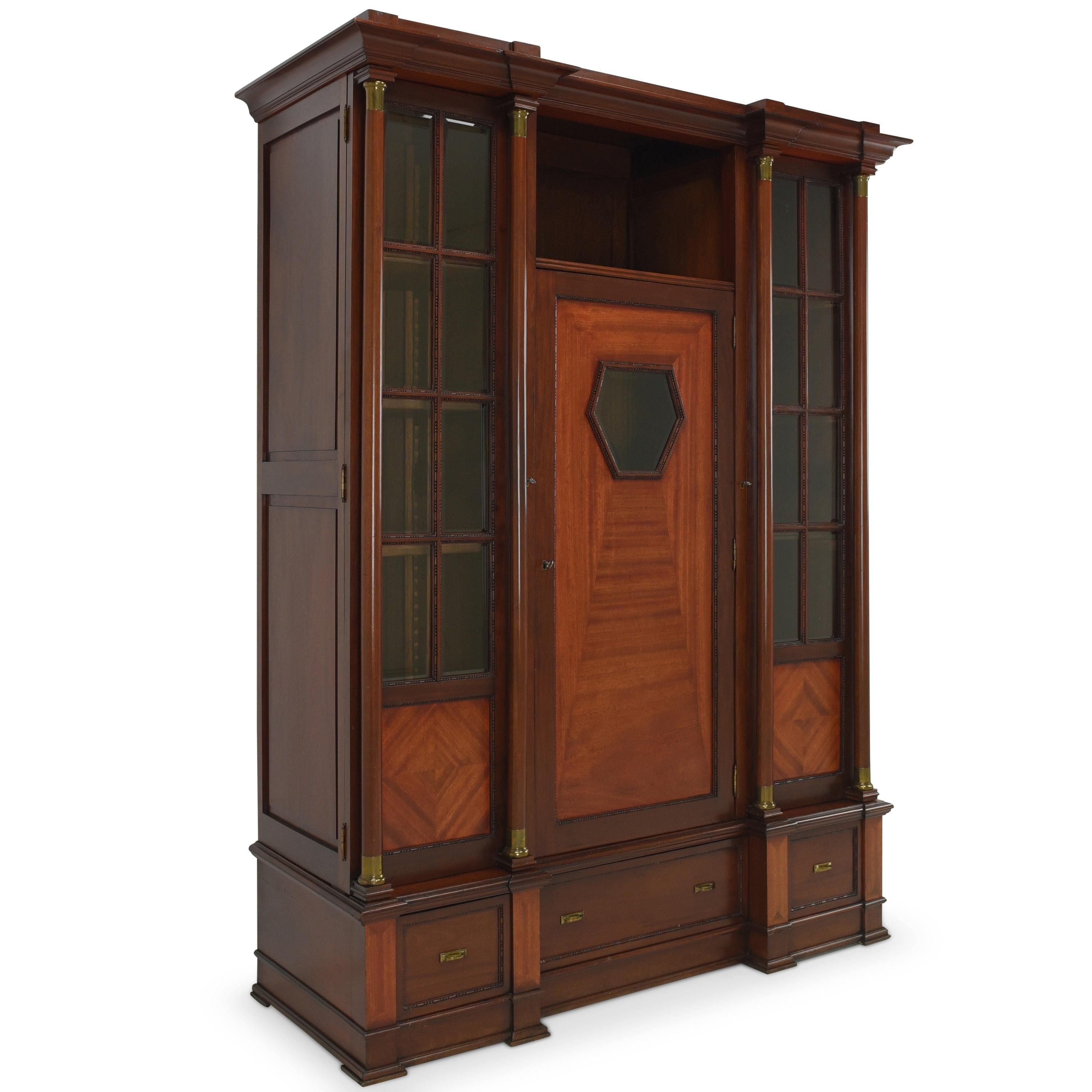 Bookcase restored Art Deco / Art Nouveau around 1920 display cabinet

Features:
Three-door model with three drawers and open compartment
Very high quality processing
Cassette fillings
Drawers pronged
Original 17-part glazing with facet