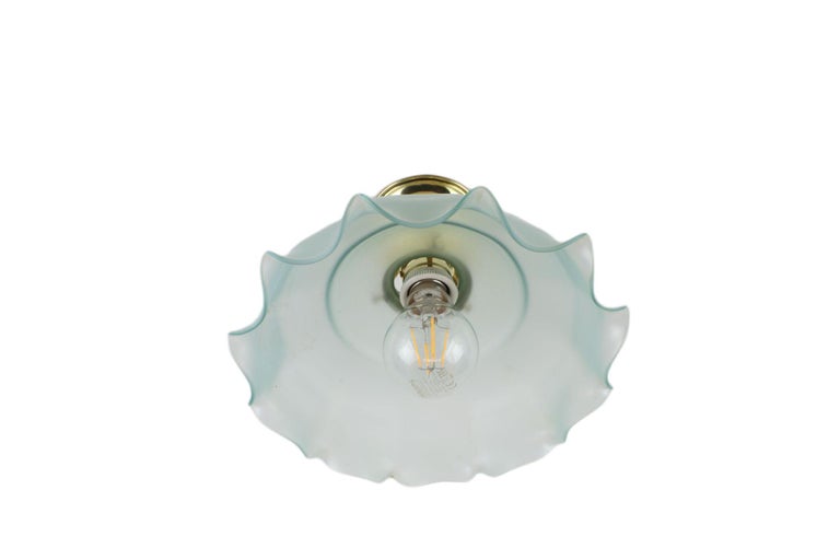 This beautiful ceiling light will stand out in every room. It boasts a green-blue shade of sandblasted glass and its history dates back to the turn of the art deco and Art Nouveau art styles.