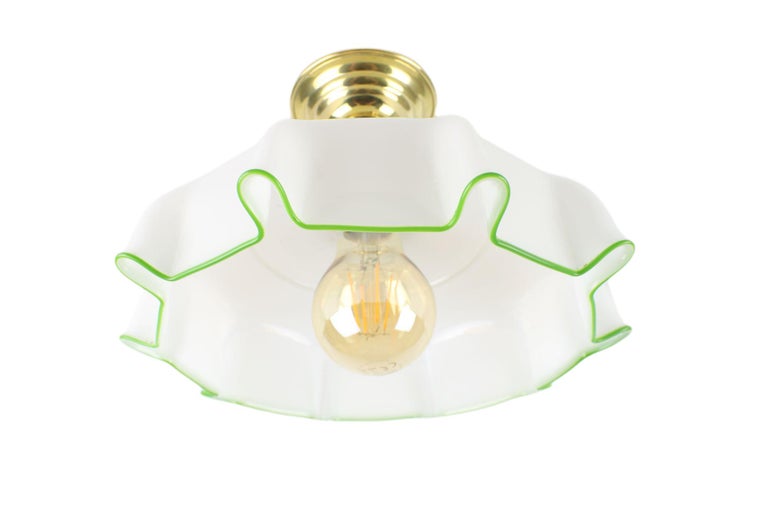 This beautiful ceiling light will stand out in every room. It boasts a white opal shade with a light green line and its history dates back to the turn of the Art Deco and Art Nouveau art styles.