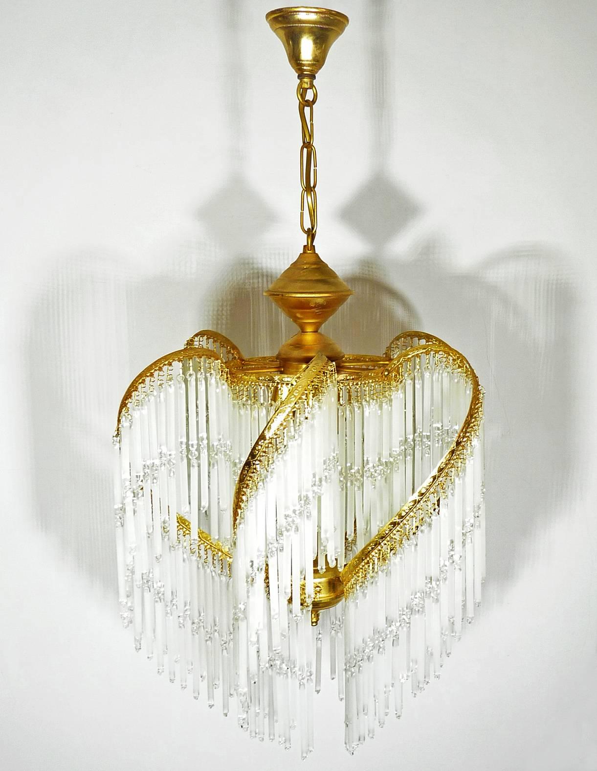 Fabulous midcentury Art Deco or Art Nouveau frosted and clear crystal glass fringe gilt chandelier.
Measures:
Diameter 16 in/ 40 cm
Height 32 in/ 80 cm
Weight: 8 lb/ 4 Kg
Three light bulbs E14/ Good working condition/European wiring.
Your item will