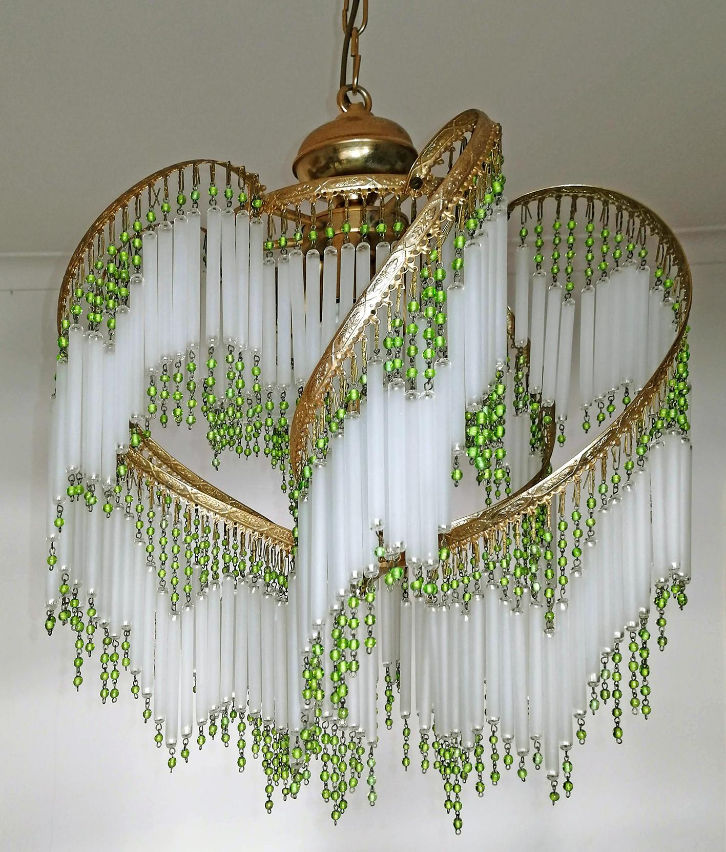 Fabulous midcentury Art Deco or Art Nouveau frosted crystal glass fringe and green glass beaded gilt spiral chandelier.
Also have a matching pair of table lamps.
Measures:
Diameter 16 in/ 40 cm
Height 31.5 in (chain = 8 in) / 80 cm (chain = 20