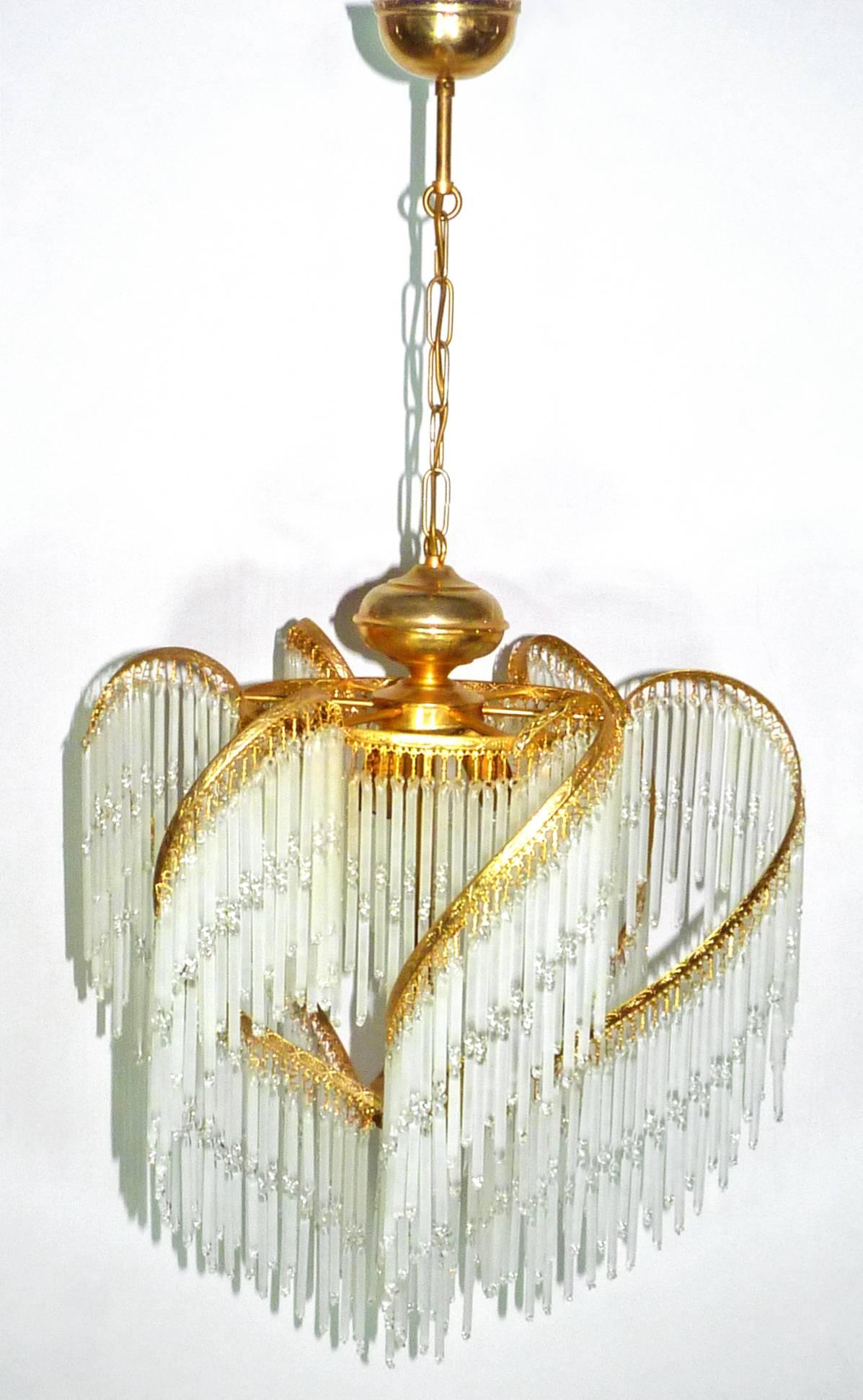 Fabulous midcentury Art Deco or Art Nouveau frosted and clear crystal glass fringe gilt spiral chandelier.
Measures:
Diameter 20 in/ 50 cm
Height 36 in/ 90 cm
Weight: 7 lb/ 6 Kg
Three light bulbs E14/ Good working condition
Assembly required. Bulbs