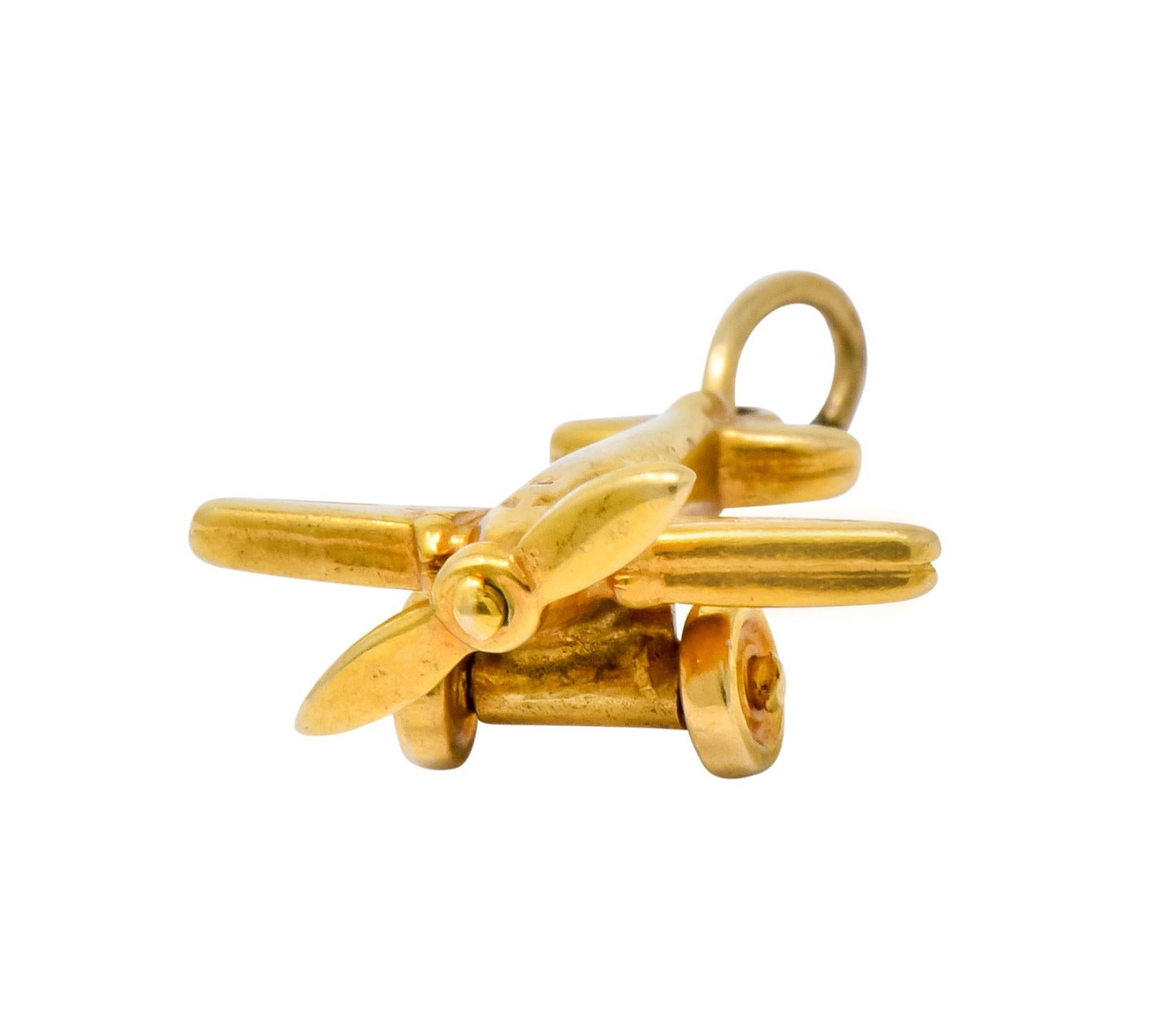 Charm designed as a propeller plane with engraved details and articulated wheels

Completed by jump ring bale

Stamped 14K for 14 karat gold

Circa: 1930s

Measures: 5/8 x 3/4 inch (including bale)

Total weight: 1.3 grams

Soaring. Fearless.