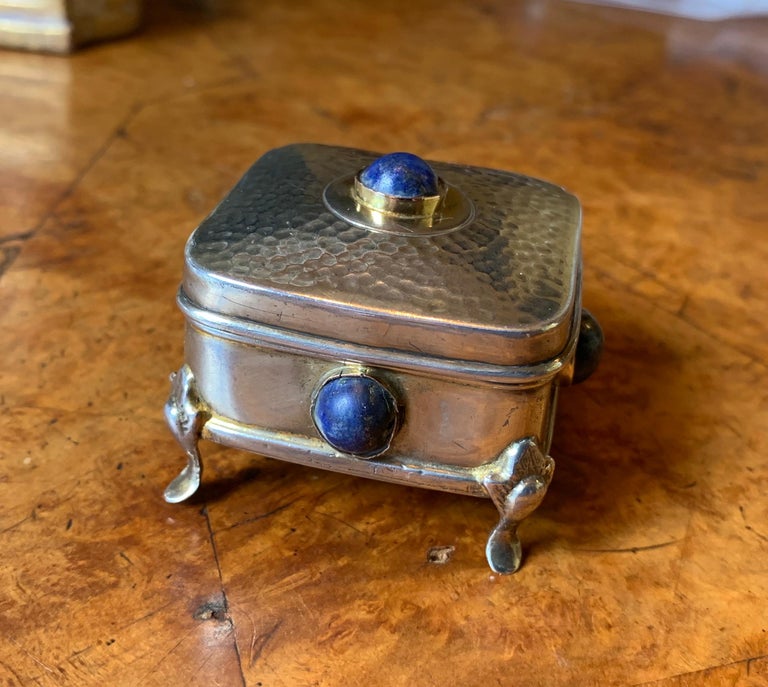 THIS IS A WONDERFUL AND RARE ORIGINAL ARTS & CRAFTS PERIOD, ART DECO STERLING SILVER BOX ADORNED WITH GORGEOUS LAPIS LAZULI CABOCHONS ON ALL FOUR SIDES AND ON THE TOP.
The Arts & Crafts silver work which is adorned with gemstones is highly coveted. 