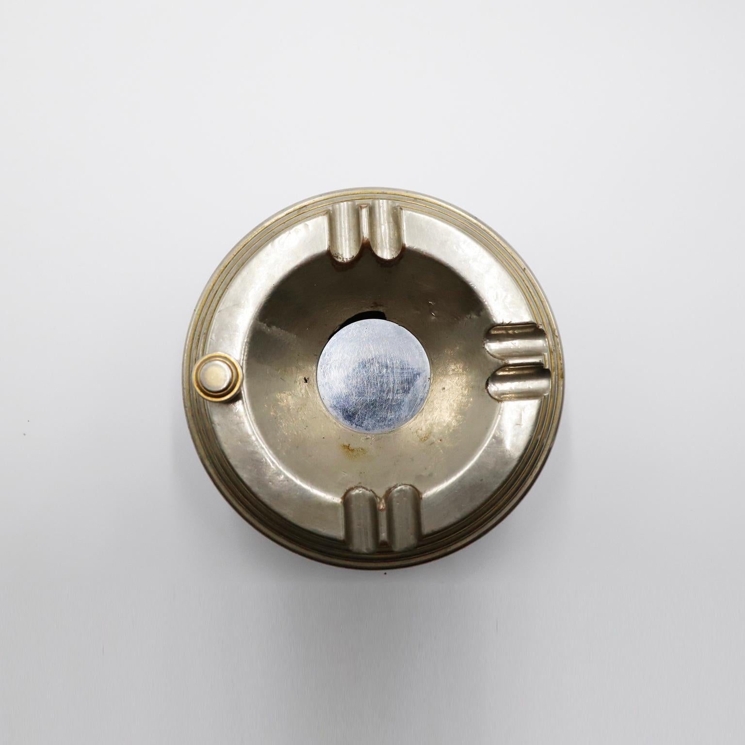 Art deco ashtray c.1940s, USA. The ashtray has a button that opens as a 'trapdoor' to hide the ash. 