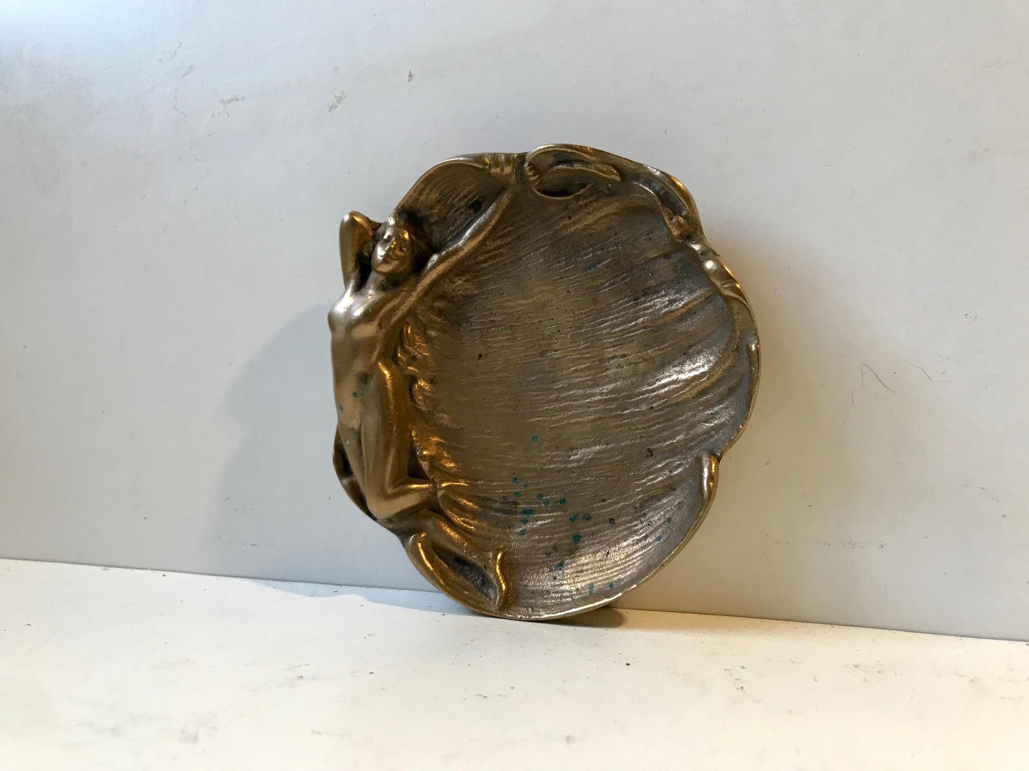 A French dish or ashtray fashioned out of brass. Delicate detailing and enlongated curves, manufactured in France during the 1920s in a style that bordlines between Art Nouveau and Art Deco.