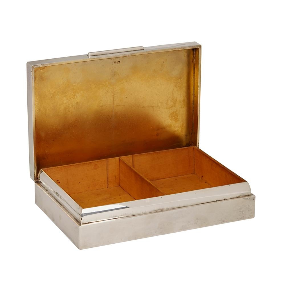 An important, fine and heavily made Art Deco Asprey & Co silver presentation cigarette box. The box has an inscription to the top reading PRESENTED BY OFFICERS & SHIPS COMPANY OF HM SUBMARINE UNRUFFLED, an important U-Boat class submarine which