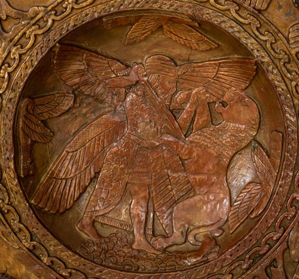 Assyrian Revival Art Deco period six-light flush ceiling mount, in cast and polychromed plaster, likely 1920s, of circular form, the borders cast with birds and geometric patterns, the round bas relief frieze with eagles consuming sacrificial bulls,