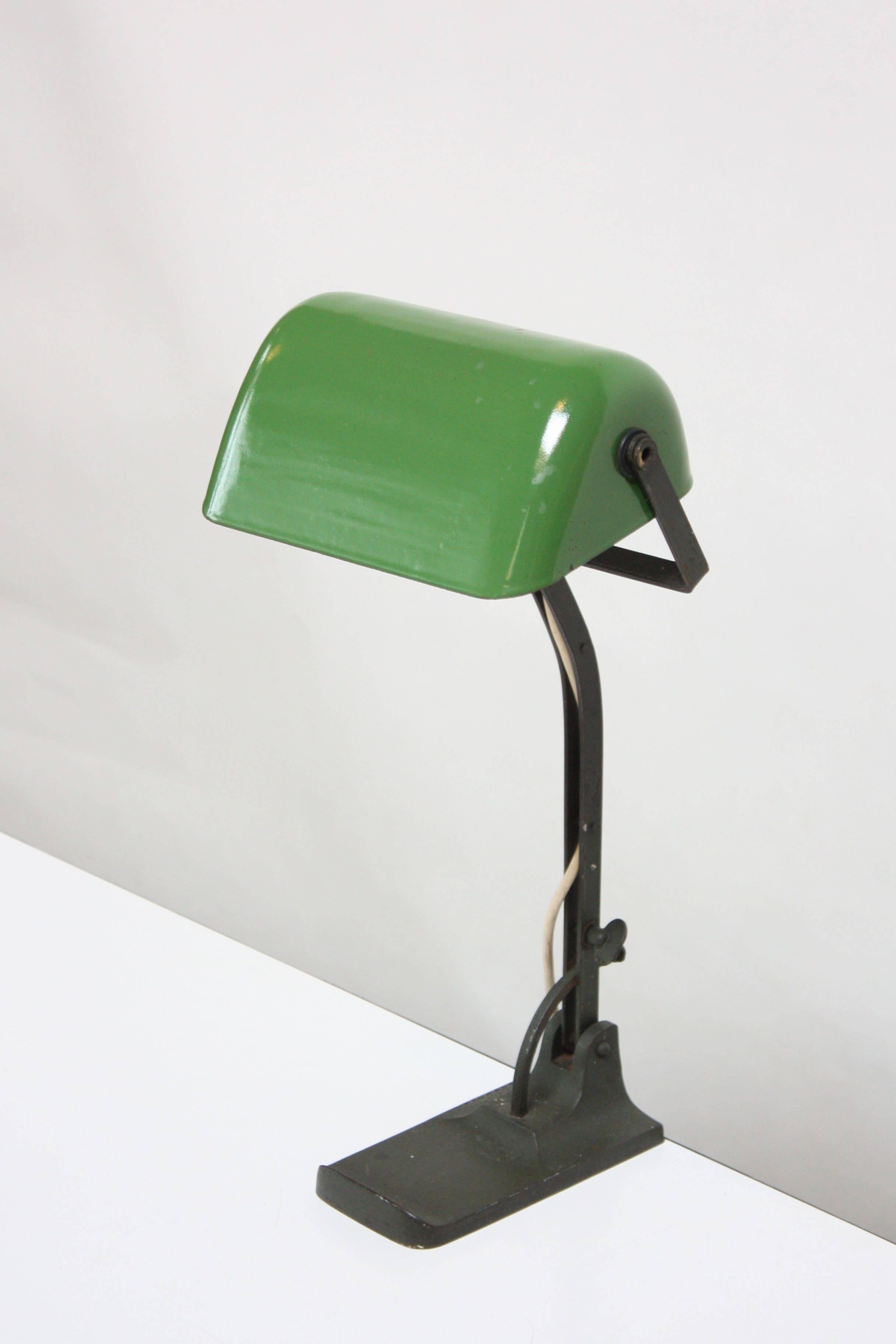 Adjustable workshop / banker's lamp by Astral (Austria circa late 1930s - early 1940s) featuring a cast metal base / stem and porcelain enameled-metal green shade. Shade and stem are adjustable (height can only be adjusted at an angle as shown, not