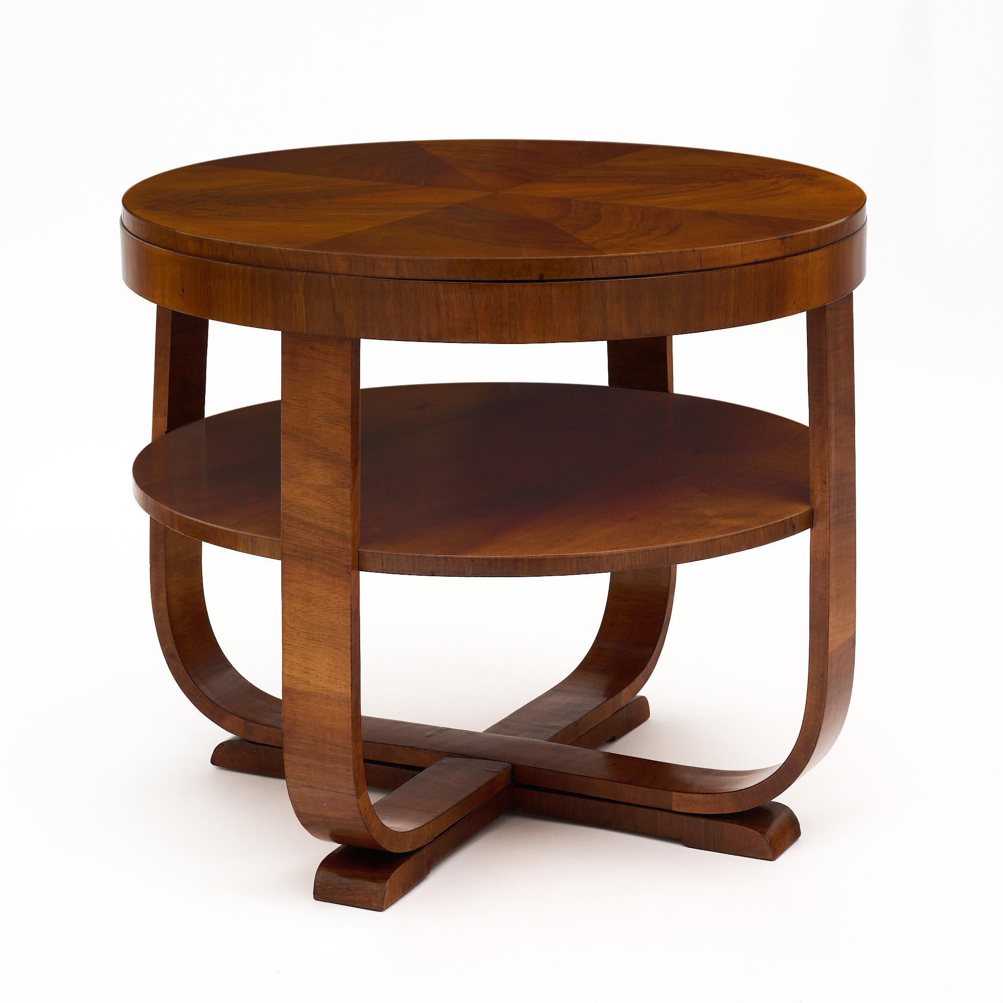 Austrian Biedermeier Art Deco gueridon from Vienna made of solid and veneered walnut with a lustrous French polish finish for a museum quality shine. Four curved legs meet at the bottom of the piece to form a quadrupled base and hold a second shelf.