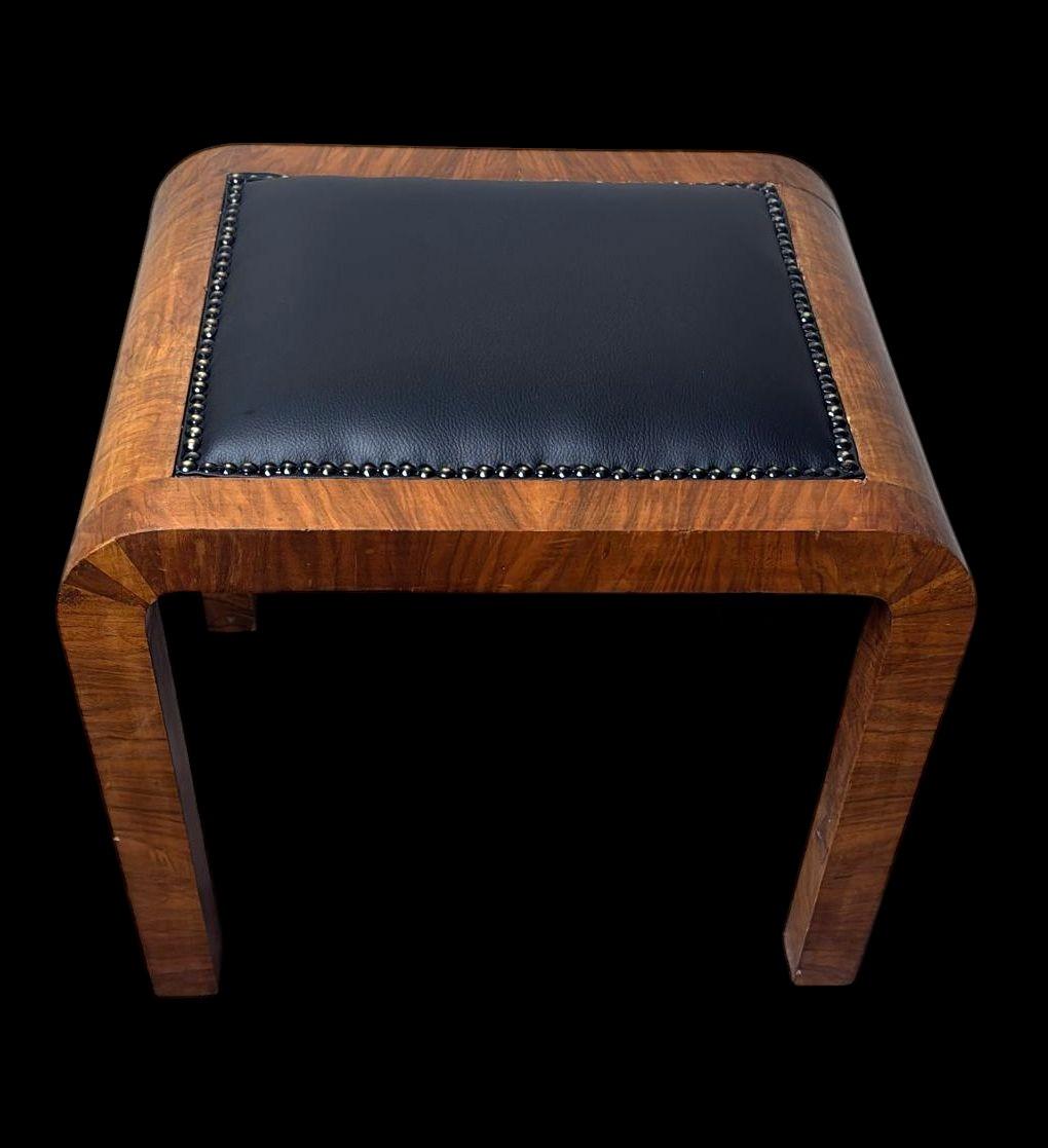 Elegant Austrian stool veneered in precious walnut burl, crafted in the 1930s and attributable to the Art Deco style. With its clean, harmonious structure, it represents a quintessential example of Art Deco design—capable of evoking period