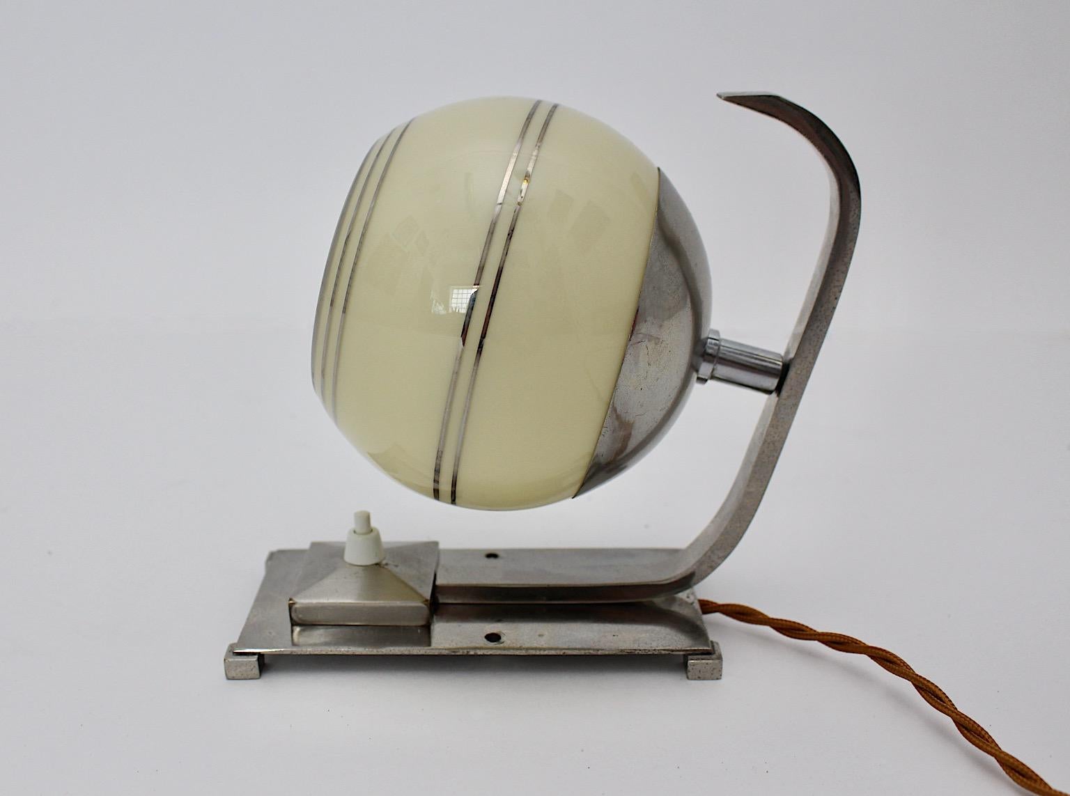 Art Deco authentic table lamp or wall light or sconce from nickel plated brass and glass circa 1925 Austria.
A beautiful lighting with nickel plated brass frame and ivory color glass shade embellished with silver stripes.
On/off switch, One E 27