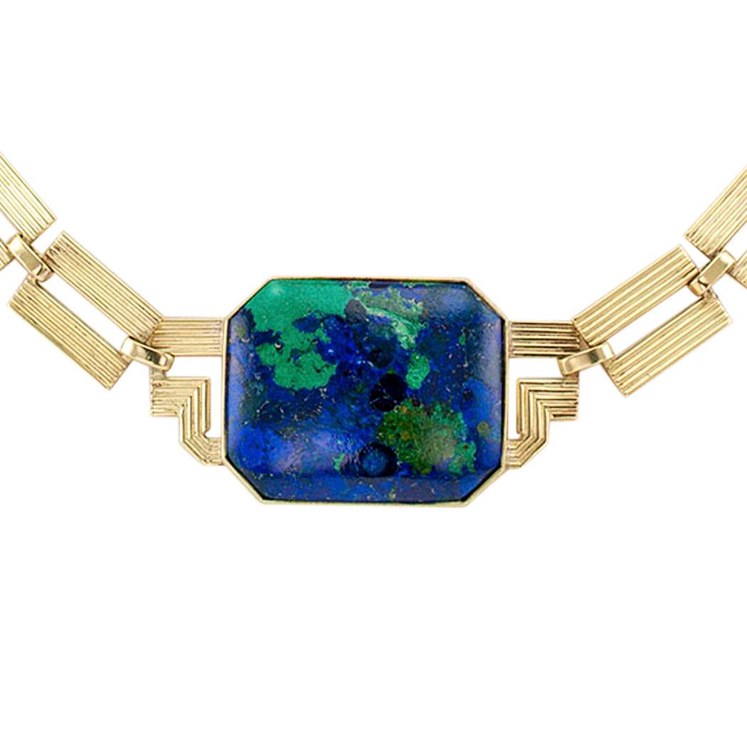 Art Deco azurite malachite and gold necklace circa 1925. Decorated on the front by a large rectangular azurite malachite displaying an abundance of gradations of blue and green color, very typical of the stone and a large part of its captivating