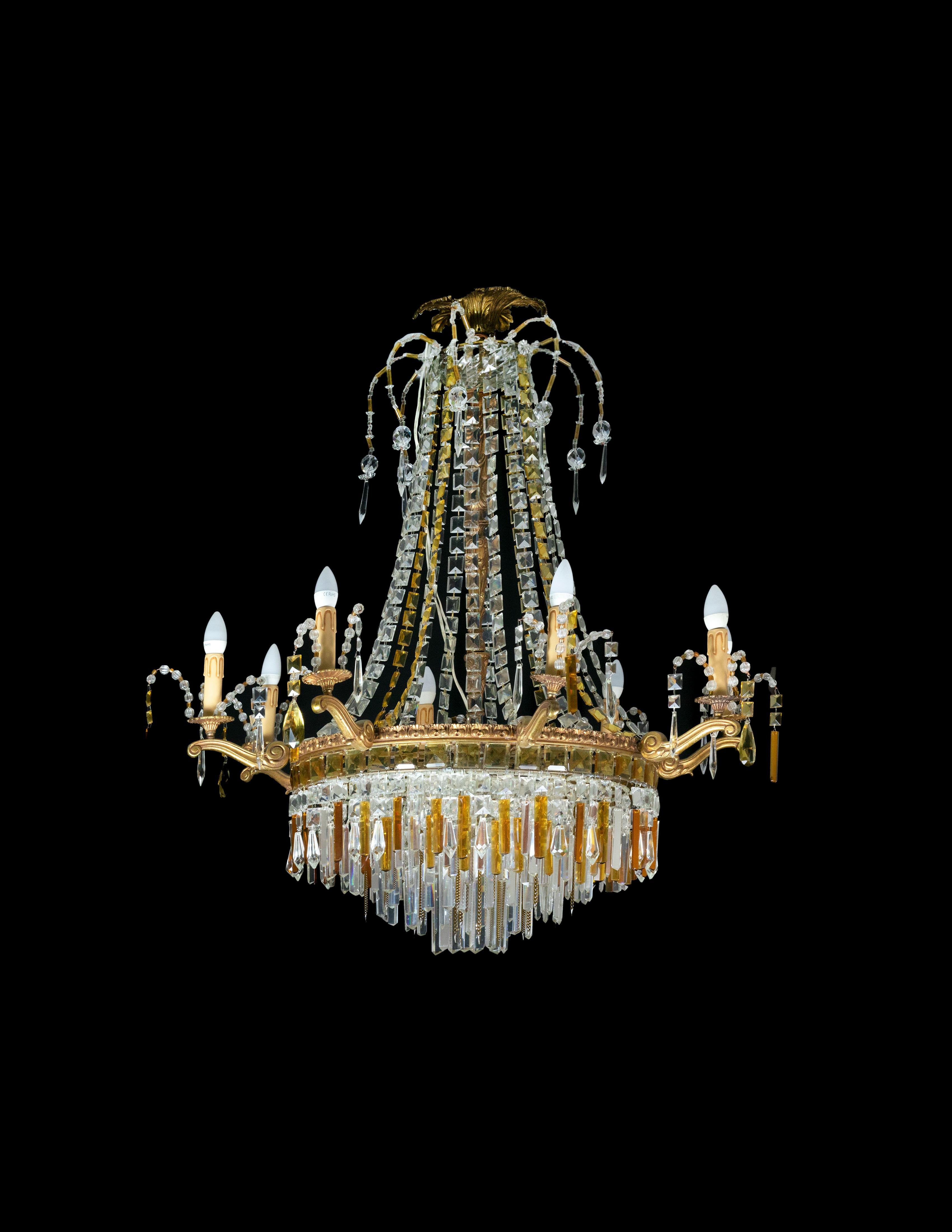 An Art Deco Baccarat style chandelier having 8 arms and 13 lamps: 8 lamps, 4 small central lamps and 1 central.

The gilt metal frame is heavily laden with various sized crystal plaquettes. 
Rare example of the great Art Deco.

The chandelier is