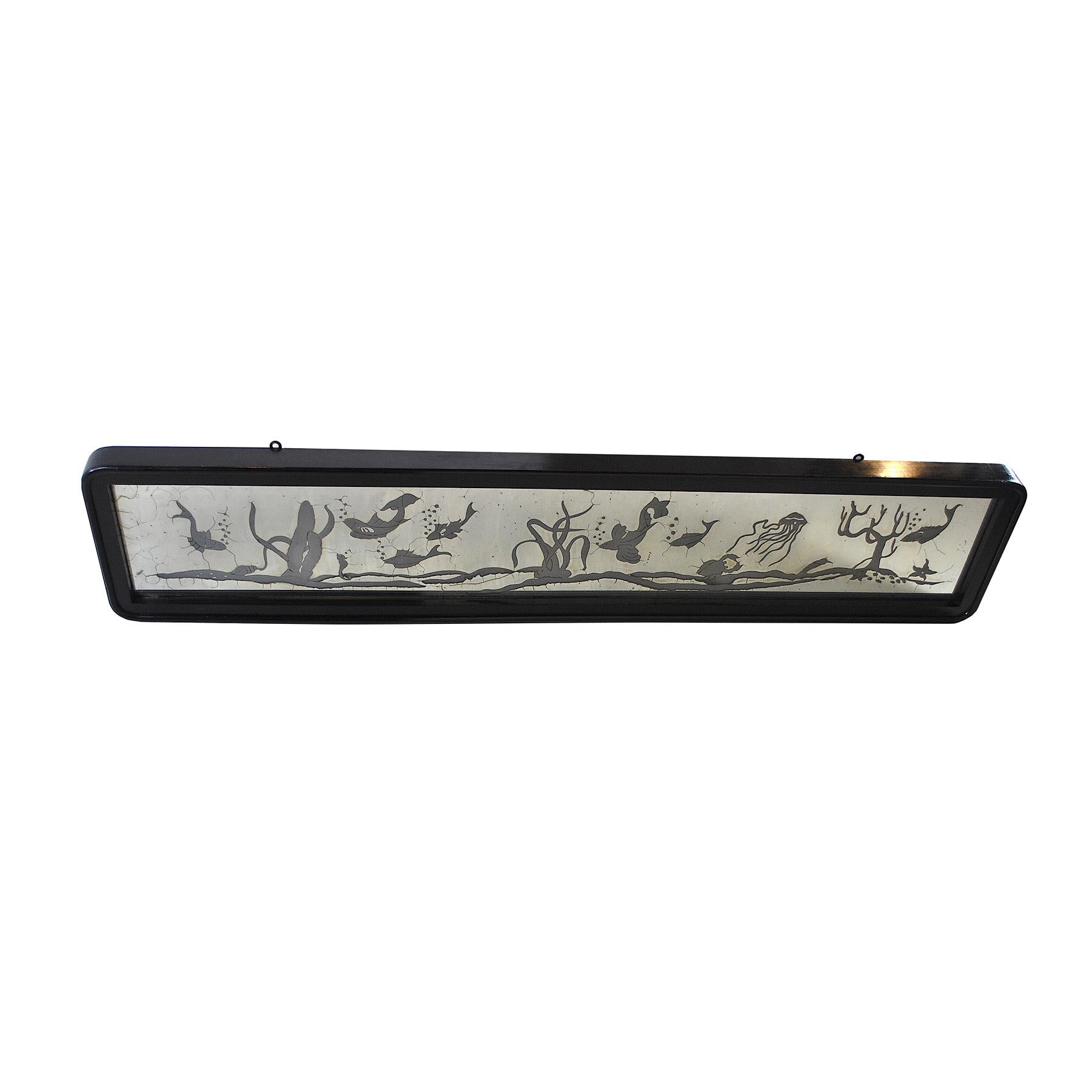 Satin mirrored glass, backlit, with black lacquered frame. The drawings depict a seabed belonging to the Art Deco era.