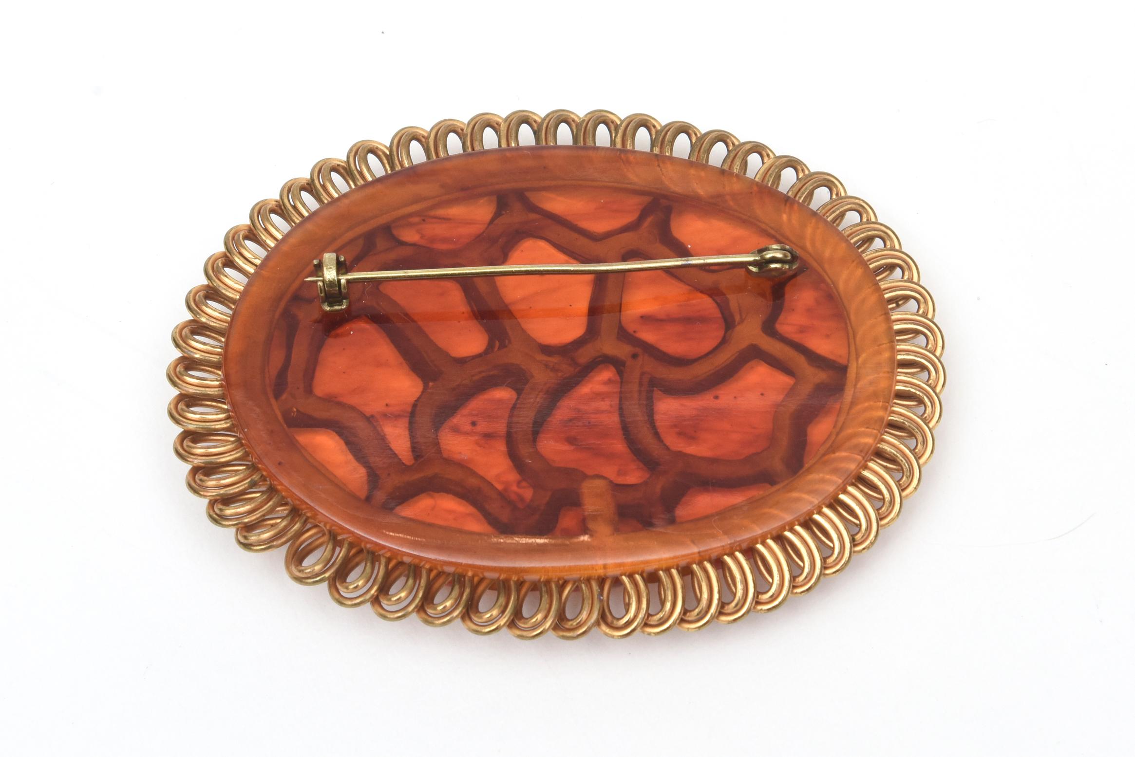 Women's Art Deco Bakelite and Brass Carved Oval Pin Brooch For Sale