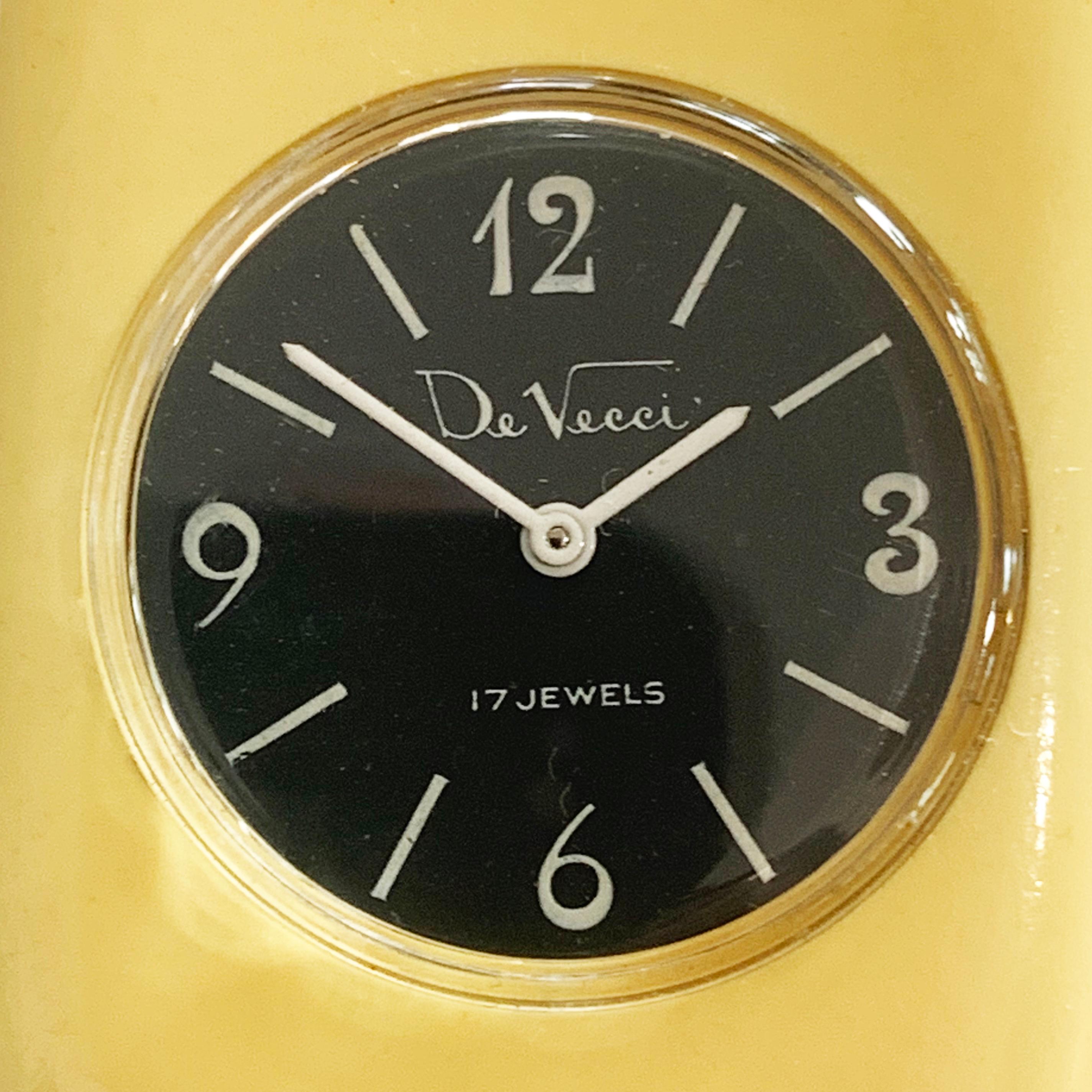An Art Deco Clamper watch in a Cream Yellow Bakelite, by “De Vecchi” with a “17 Jewel”  movement, as marked to the black metal face, with white hands and Arabic numerals, with a touch of Nouveau influence with “curls” to ends of numerals, for the 3,