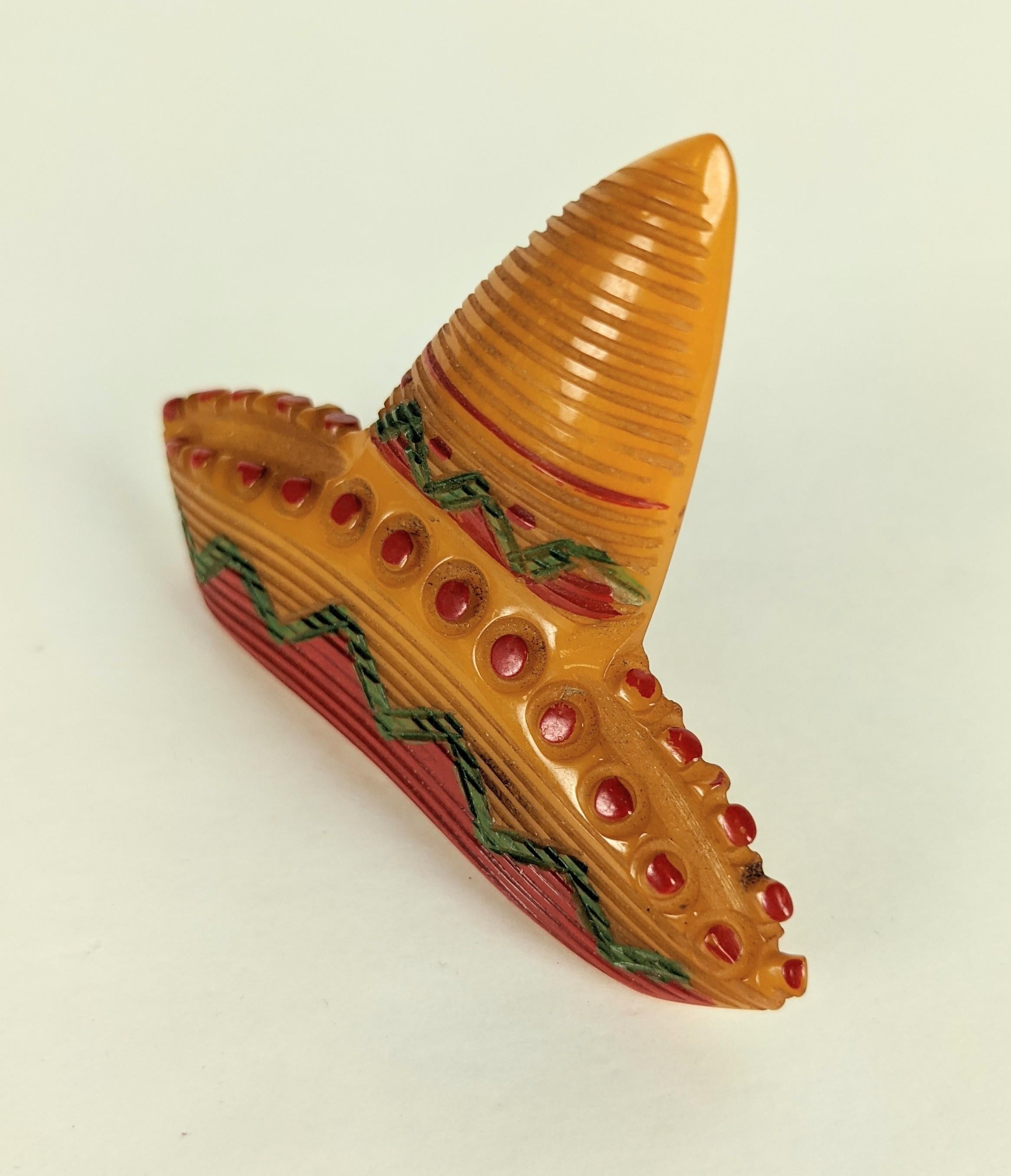 Wonderful Art Deco Bakelite Sombrero Brooch hand carved in mango toned bakelite with hand cold painted accents. Folk art novelty figural from the Art Deco period USA, 1930's. 
3