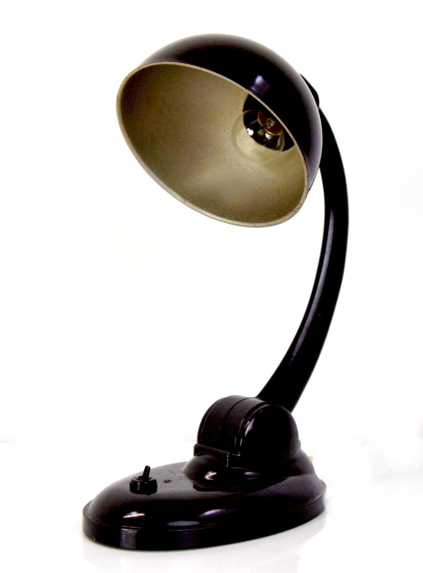 A stunning example of Eric Kirkman Cole's Art Deco stylish table lamp in superb brown bakelite. A model designed in the 1930s and produced in European countries under license. This particular design carried on being manufactured up and until mid