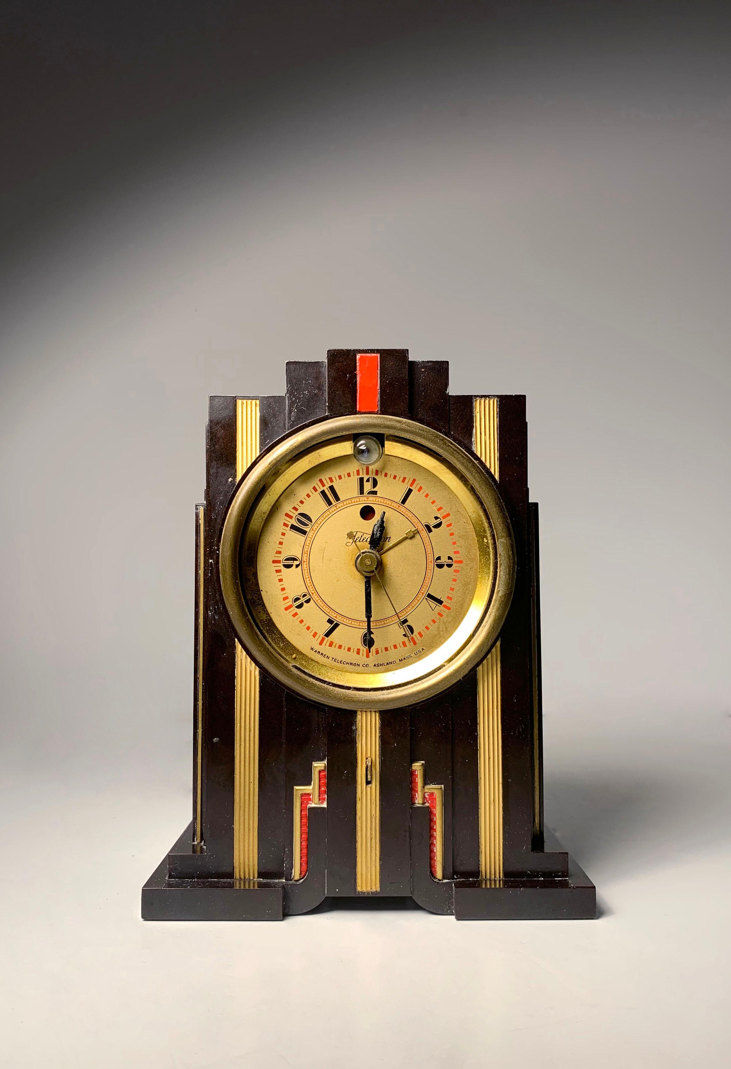 Beautiful Period Art Deco Bakelite Telechron Clock in the manner of Paul Frankl

As Found Condition. Missing the glass lens. the metal piece in front is loose. Most importantly, Walnut Bakelite appears to be in very clean condition.  Am assuming the