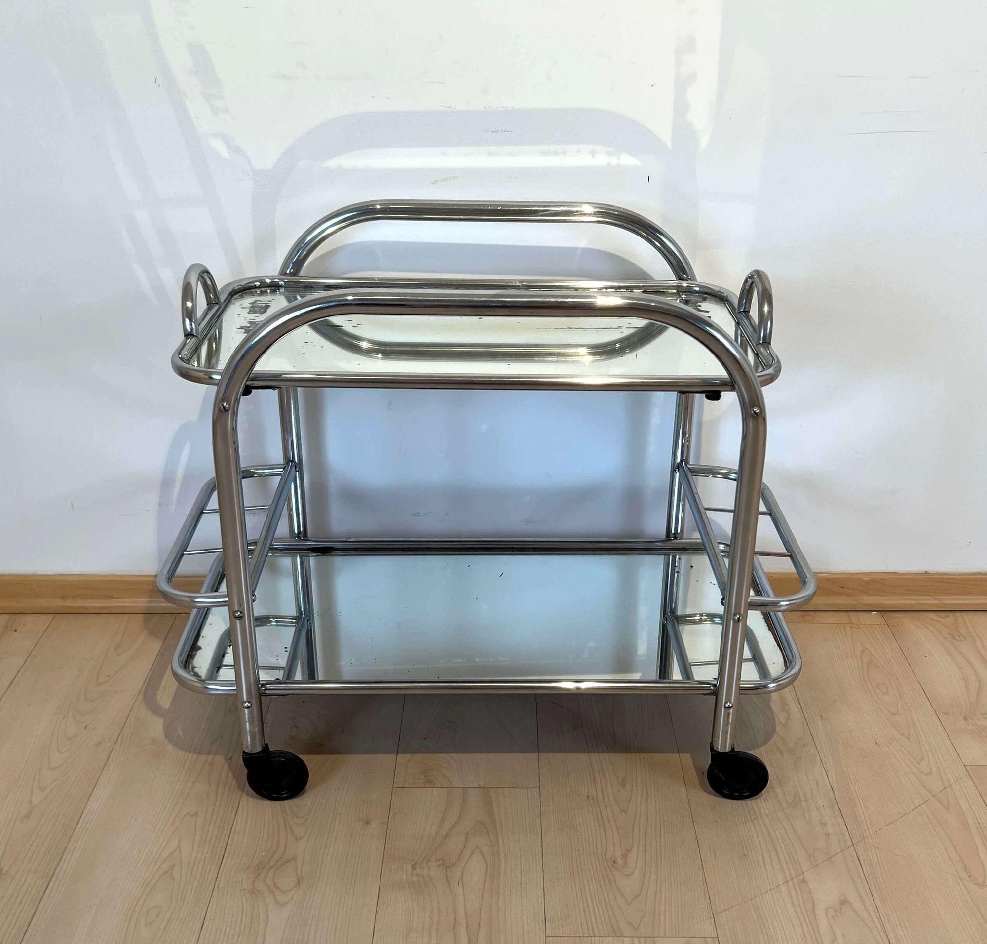 Art Deco Bar Cart or Serving Trolley, Chromed Steeltubes, France circa 1925

Design: Robert Mallet-Stevens (Paris, 1886 - 1945)

Chromed thick steel tube. Original old mirrored glass. Upper tray can be removed for serving. Mobile on 4 casters.
6