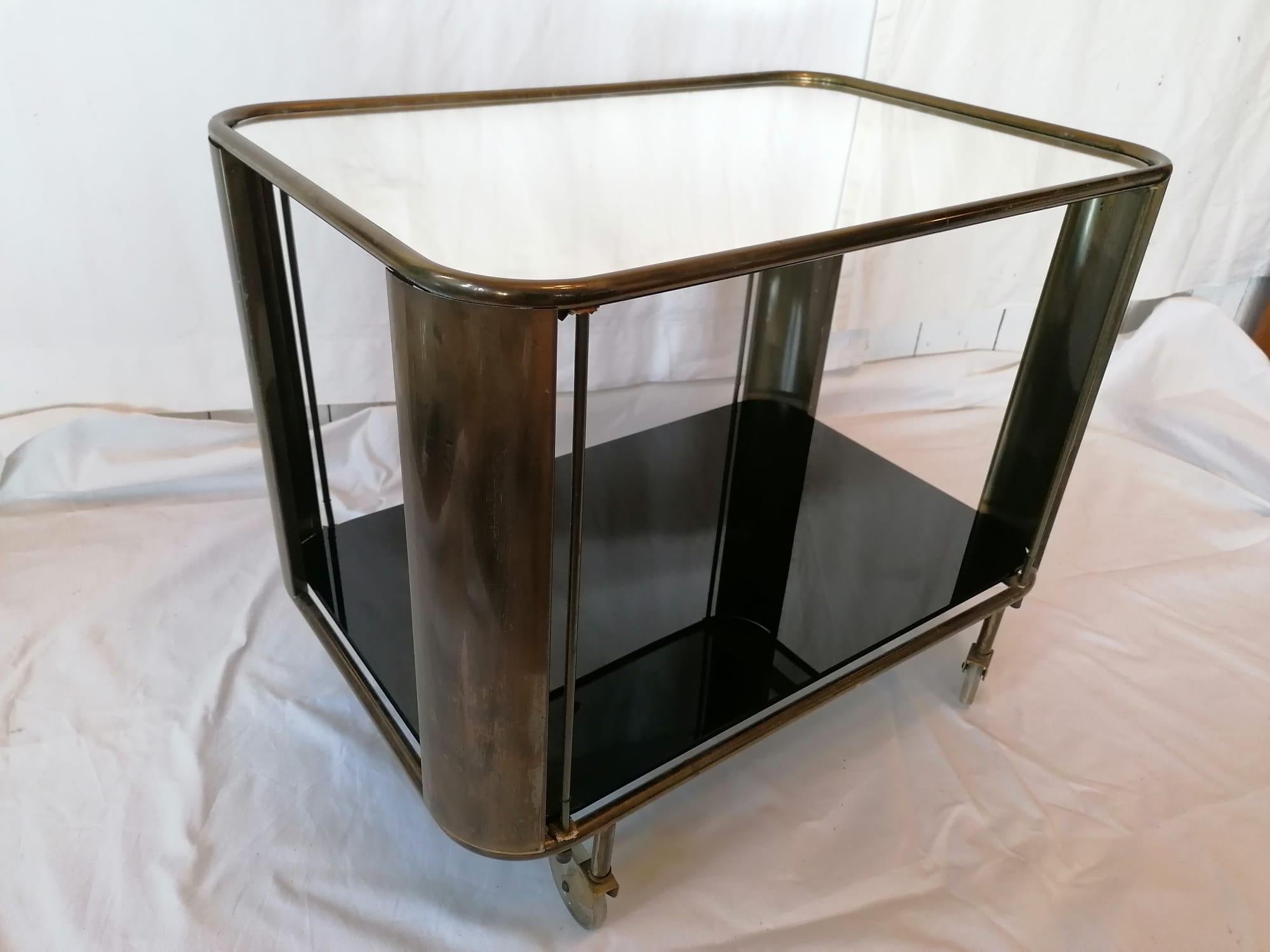 Art Deco bar cart, hardwood frame with plywood with black glass button and mirror top on glass (plexiglass?) wheels. Made in Austria in the late 1930s. 