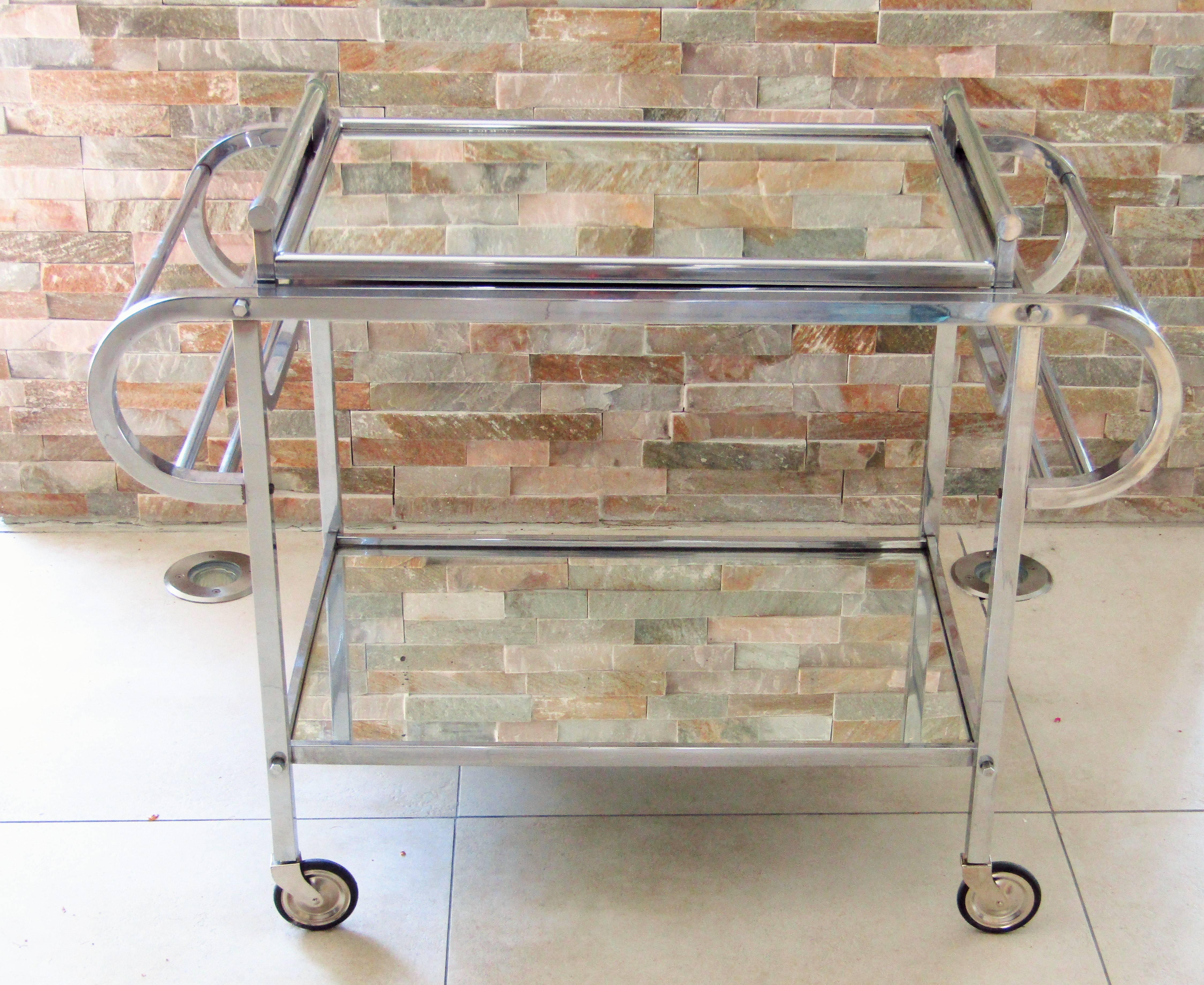 Art Deco bar cart, France, 1935. Original chrome. Tray with glass handles. Cart mirrors with some small blind spots. Tray mirror 100% perfect. Castors as new. In the style of jacques adnet.

 