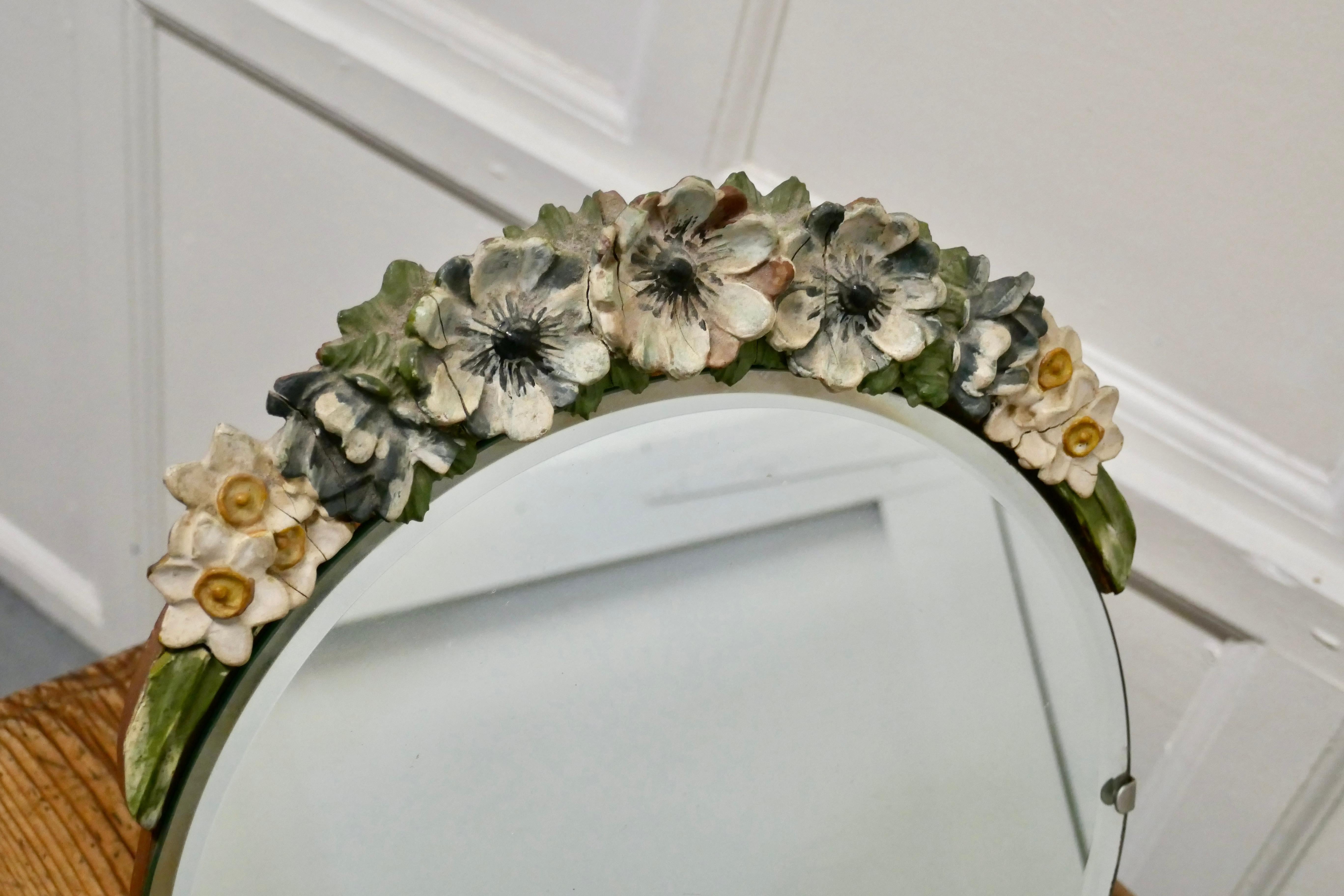 Art Deco barbola work wall mirror

A classic of its time this mirror is a pretty round shape, with a barbola work tiara, it has an all round original beveled edge.
The back is a gold painted easel stand
All in good condition for its age minor