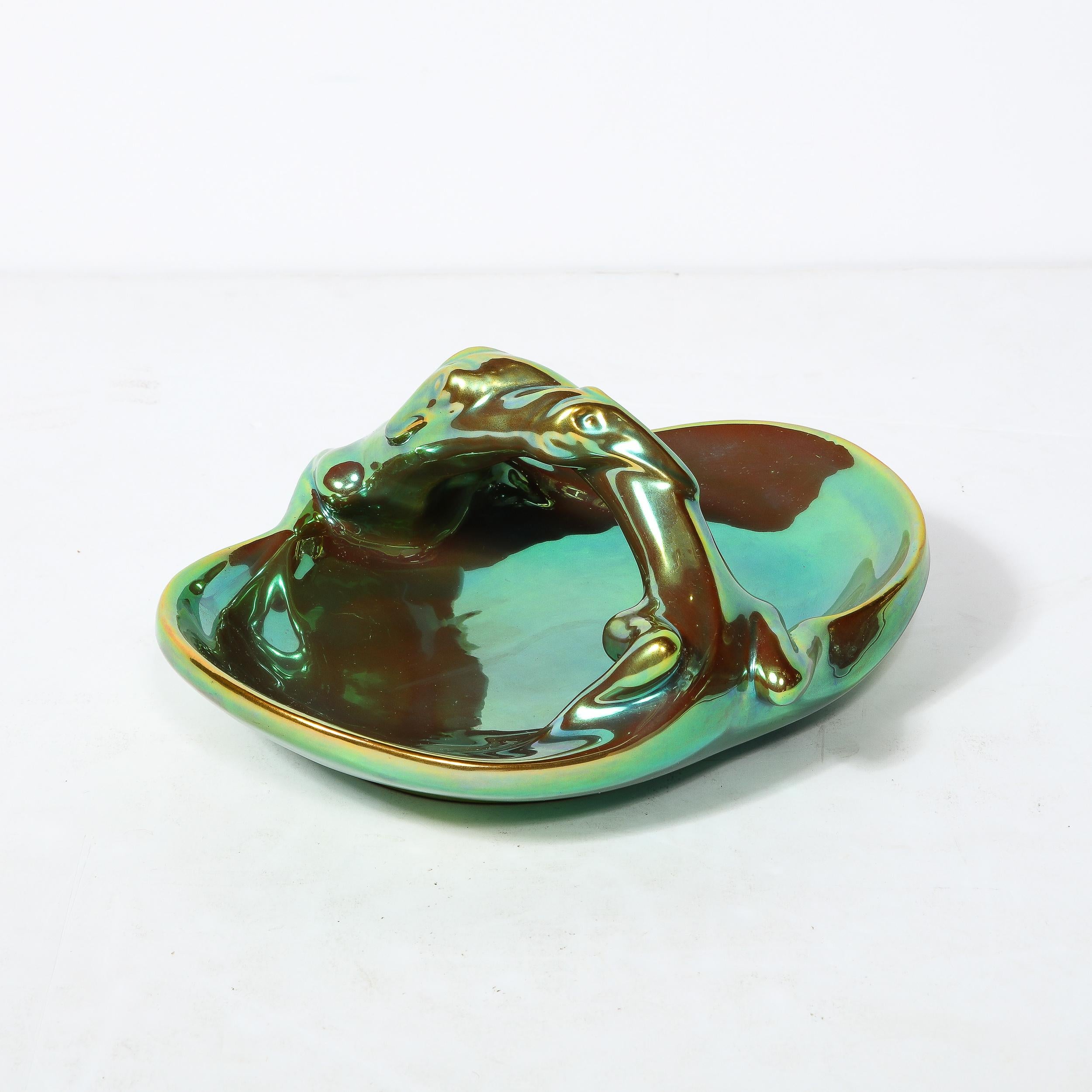 This Lovely and captivating Art Deco Ceramic Dish by Zsolnay Eosin Originates from Hungary, Circa 1930. Reflective Greens and violets gleam from stunning surface of the iridescent metallic glaze.Basket style featuring a sculptural handle of two