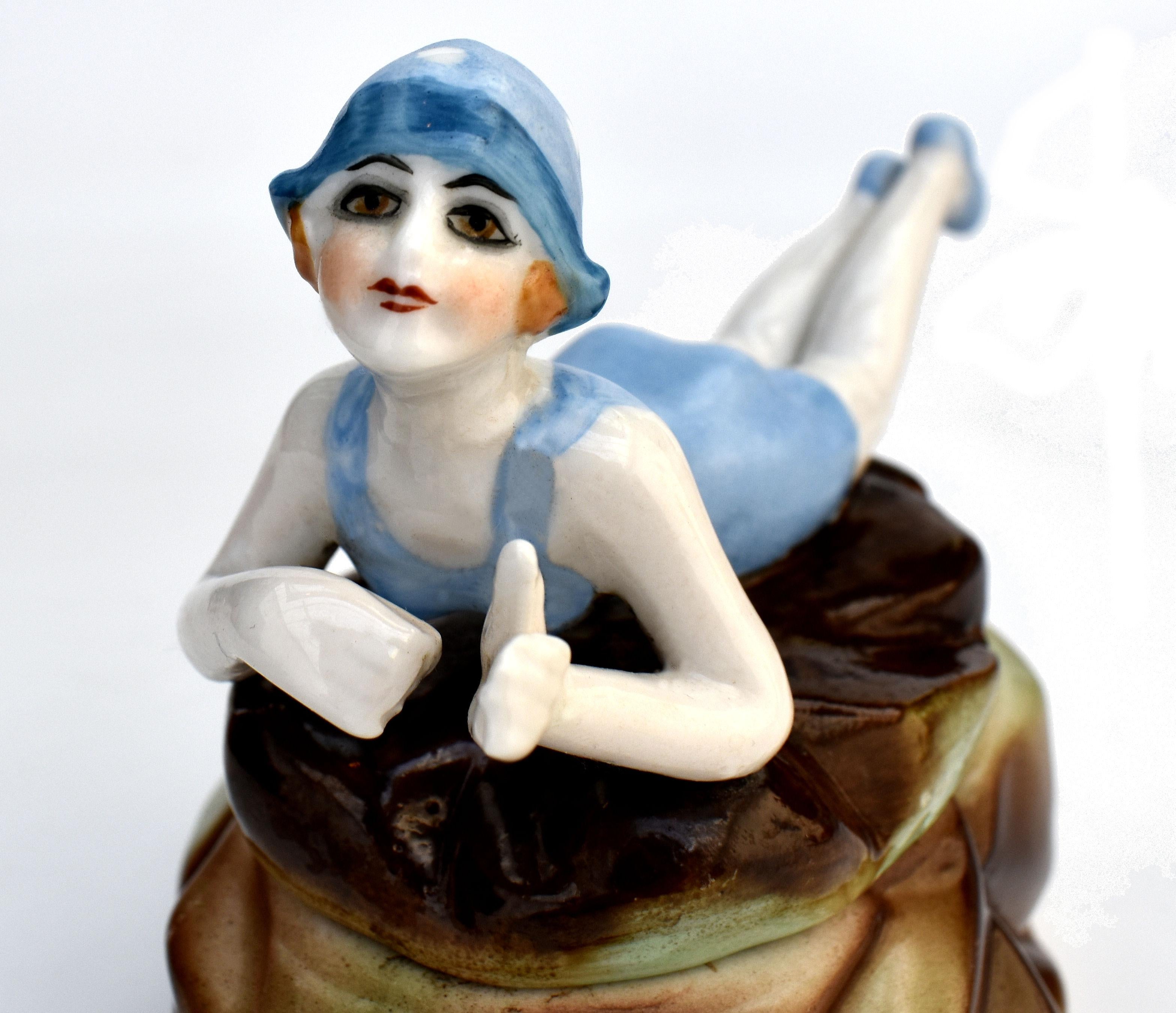 Not to be confused with the many reproductions of bathing belles circulating at the moment, this is an original 1930's Art Deco bathing belle sat upon a rock with her parasol open shading her from the bright sunshine. A rare Art Deco trinket box is