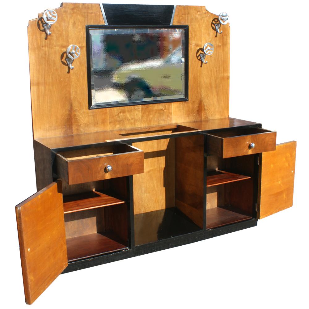 An Art Deco cabinet which could be used as a bathroom vanity.  Contrasting wood veneers and ebonized top and sides.  Shelved storage and drawers.  Beveled mirror.