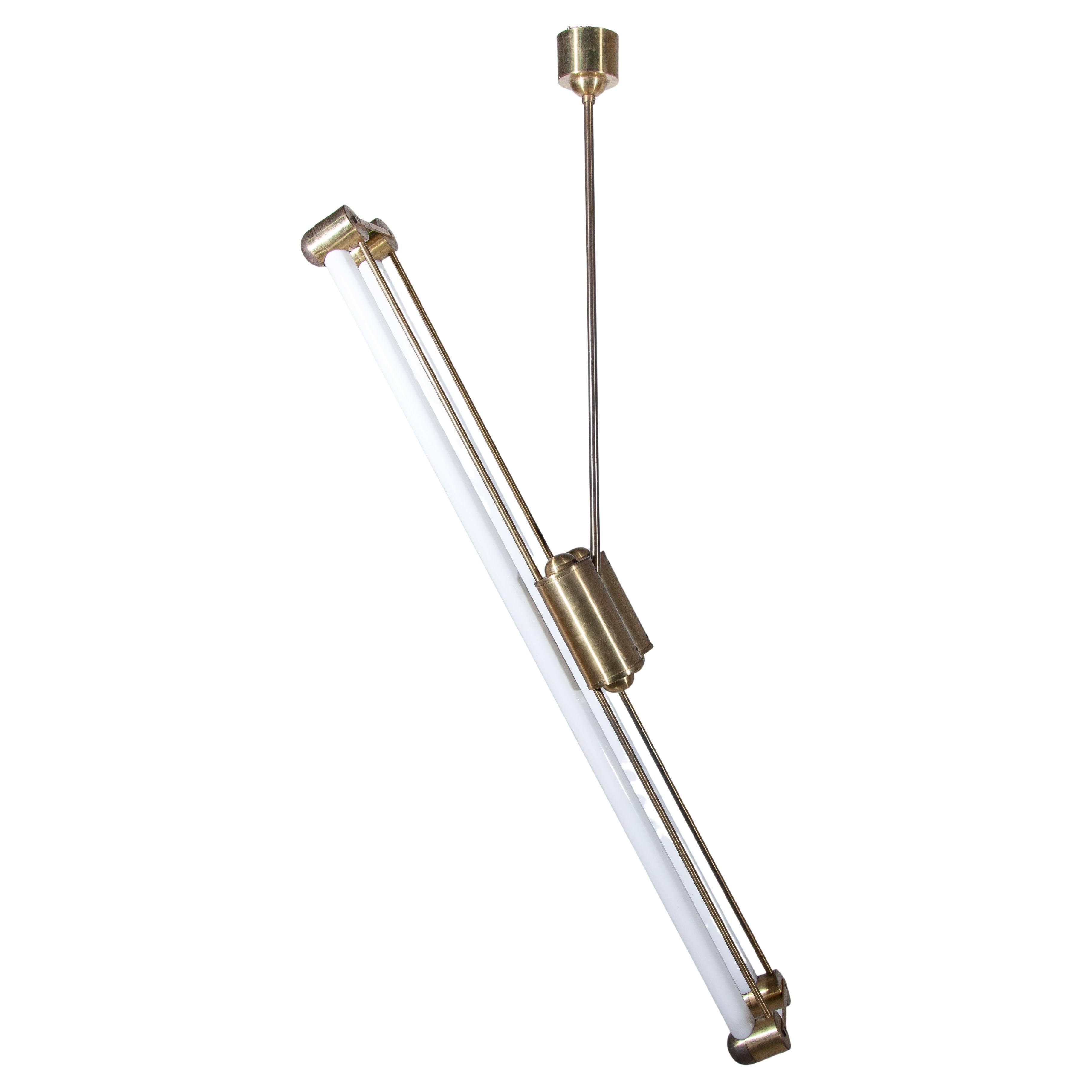 Industrial rare counterbalance 2 tubes bauhaus lamp designed by Kaiser. The sleek Brass lines of the lamp that can be moved in all possible positions to illuminate your living space in a balanced way is a playful object of light. A beautiful light