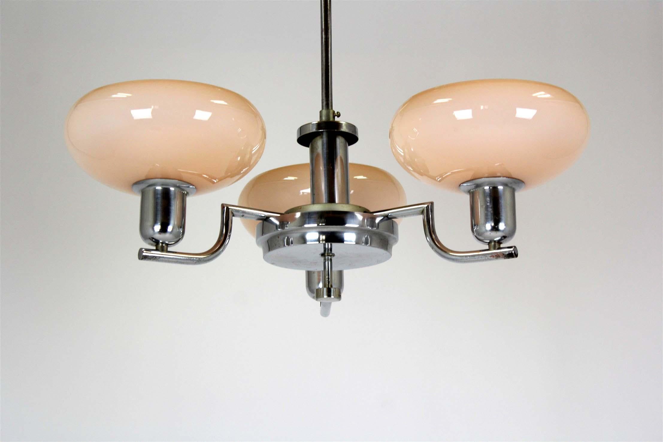 Hanging lamp by Napako, made in Czechoslovakia in the 1940s. It has three arms with original glass shades and a chromed metal structure. A stylish and authentic piece of vintage Czech design.
Good vintage condition, patinated chrome surface