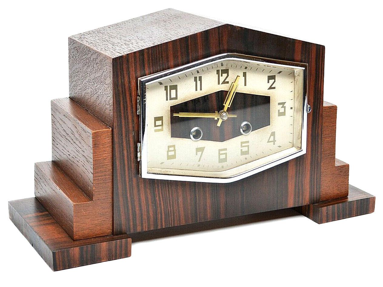 For your consideration is this superbly stylish large German Bauhaus mantel clock manufactured in the 1930's. This is a beautifully crafted and seldomly seen art deco table or mantle clock showcasing different types of wood like calamander in a