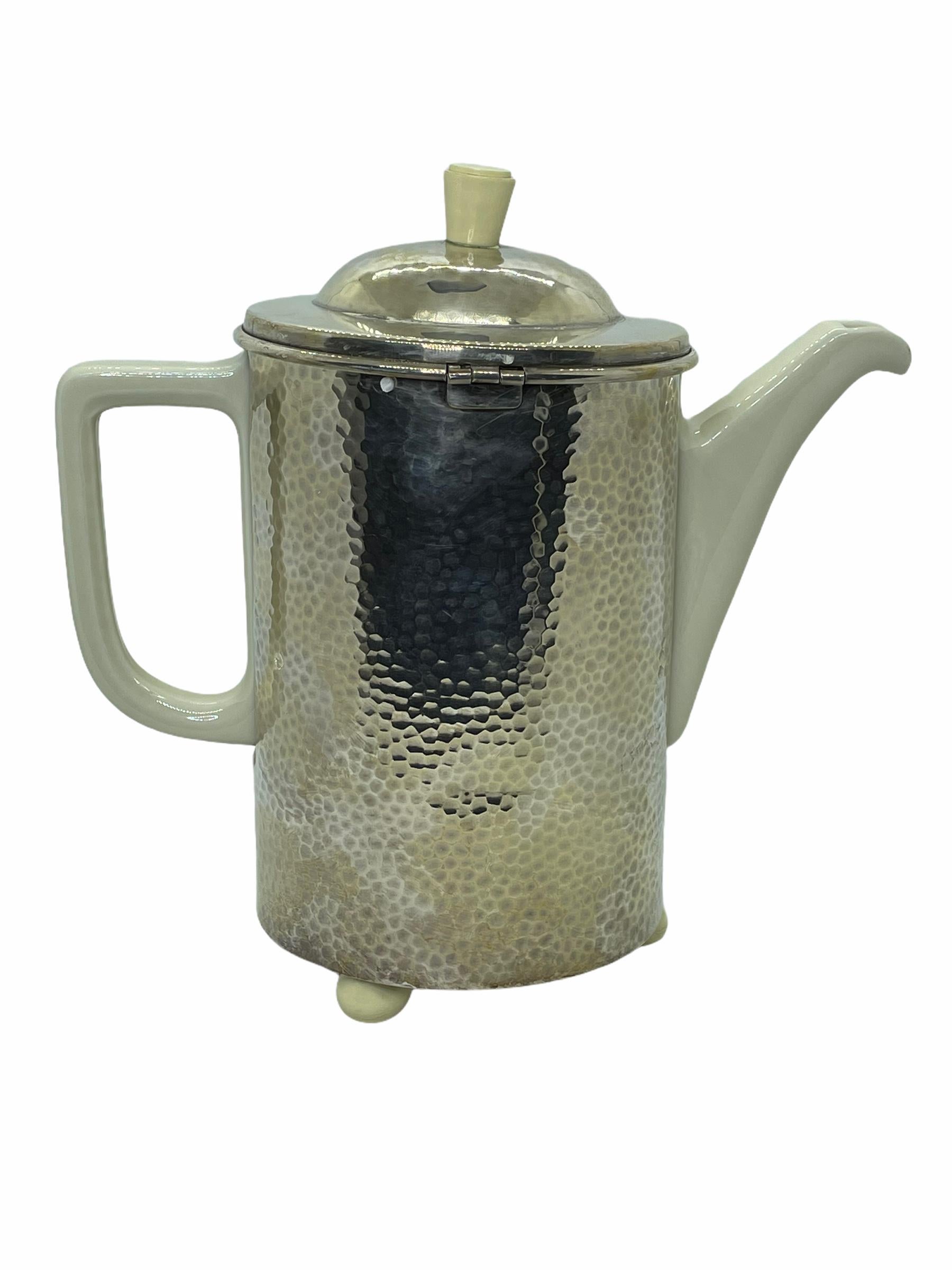 Art Deco Bauhaus Hutschenreuther coffee pot hammered WMF metal cozy this handsome vintage coffee pot marked Hutschenreuther Bavaria Germany is snugly nestled in a WMF D.R.P. hammered silver-clad over copper cozy, and lined with a charcoal grey wool