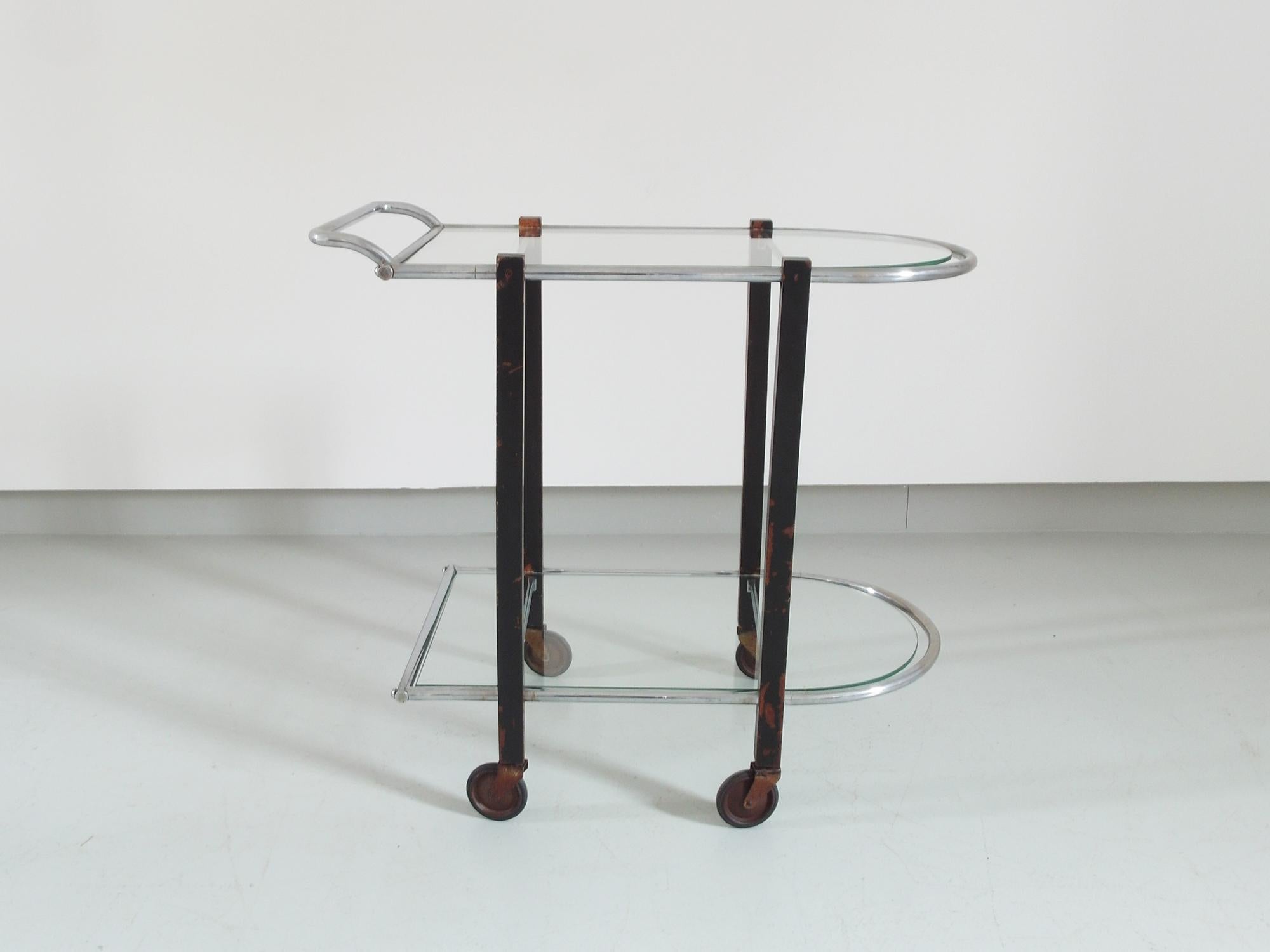 Art Deco modernist Bauhaus bar cart, or serving table or trolley, designed and executed in the 1920s-1930s in the Netherlands. This modernist cart is made of chromed metal, ebonite wood and glass. We kept it in full original condition with