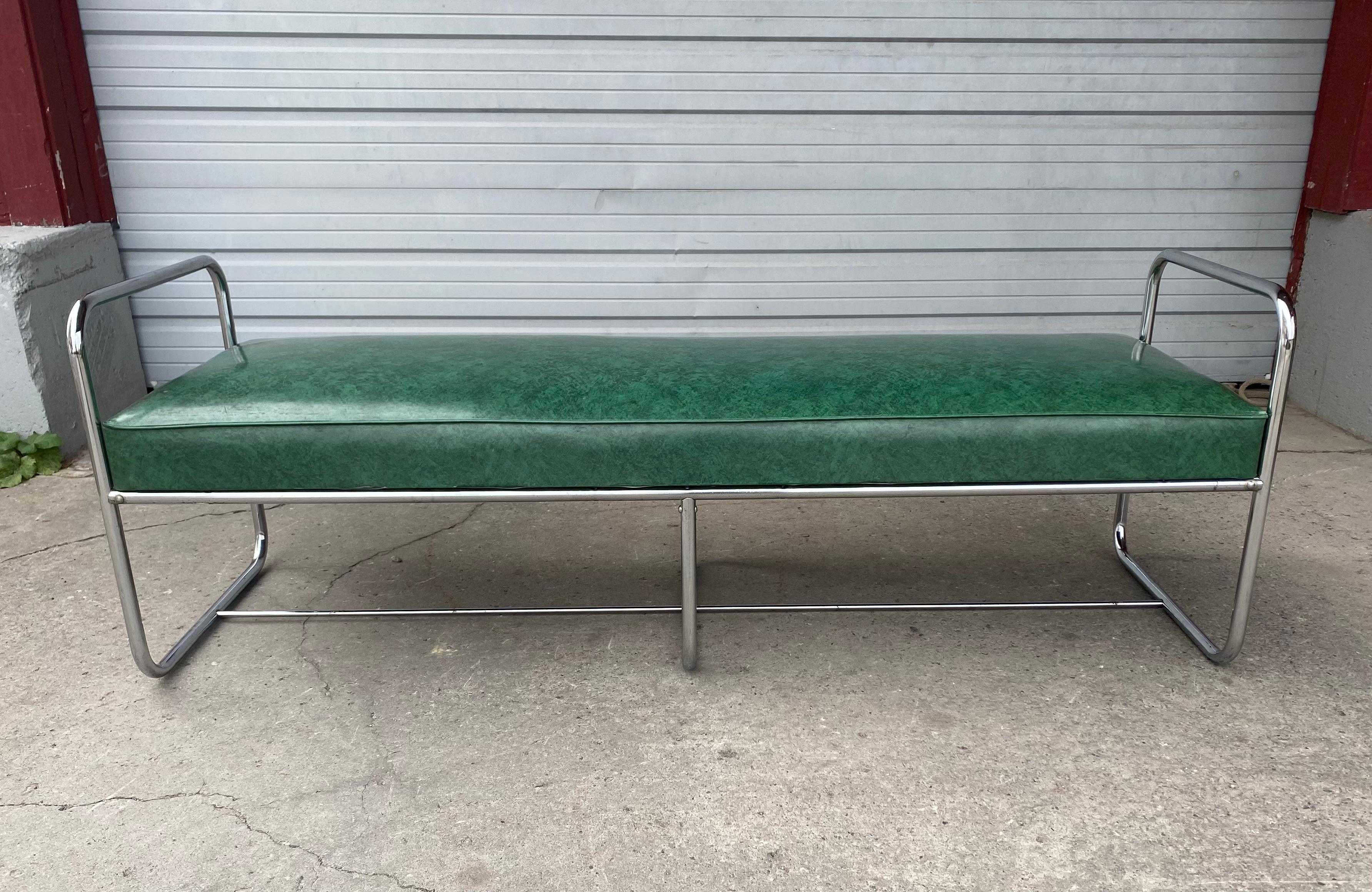 Classic Art Deco / Bauhaus style Tubular chrome bench designed by Wolfgang Hoffmann for Howell, chrome in great original condition, reupholstered (most likely in the 1950's-60's) in green naugahyde, chrome frame arms measure 24