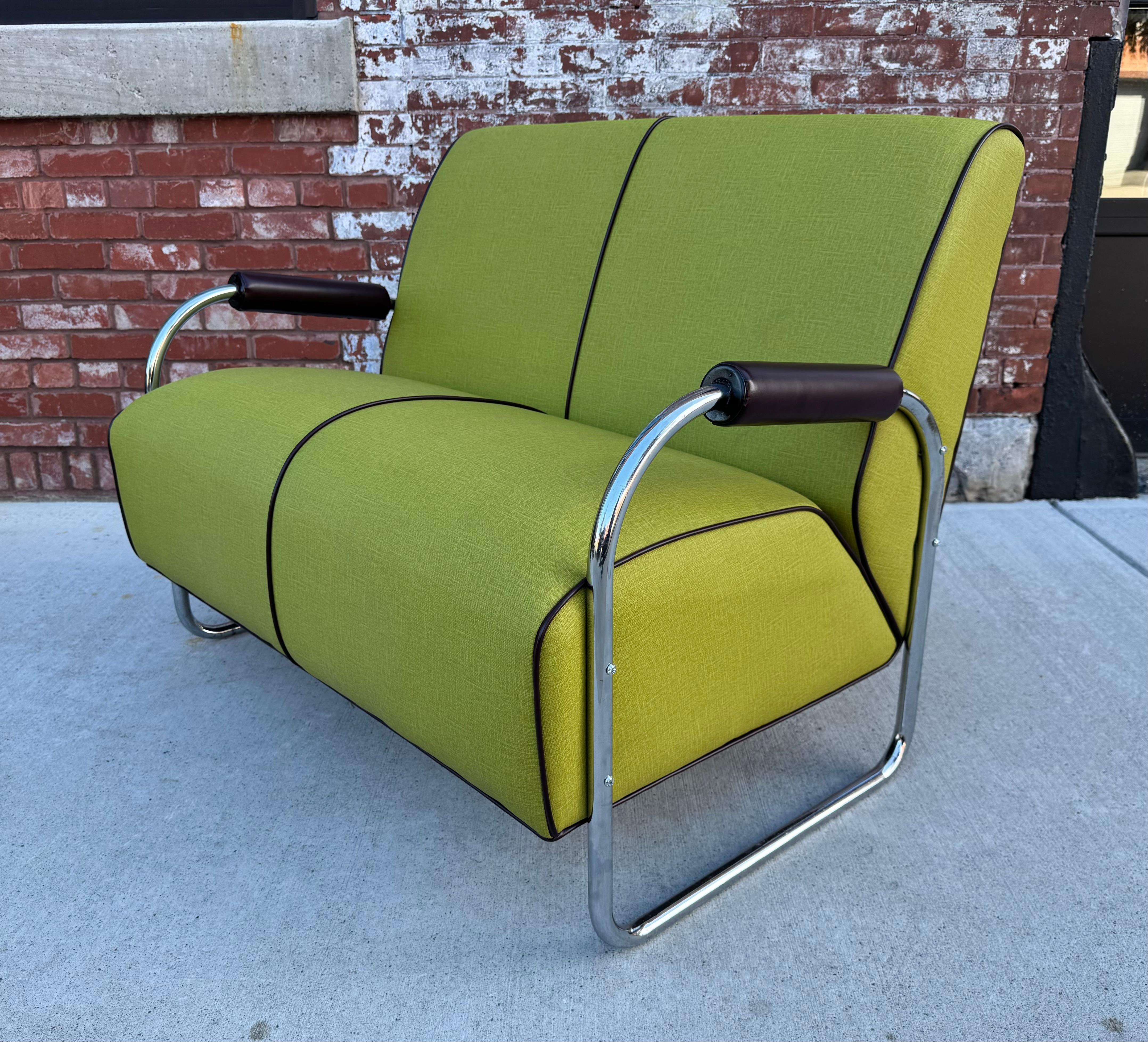 Meticulously restored Art Deco / Bauhaus Tubular Chrome Settee attributed to Gilbert Rohde.. Extremely comfortable,, Leather tootsie-roll arms and welting . Great colors. Tubular chrome frame in great original condition. Hand delivery avail to New