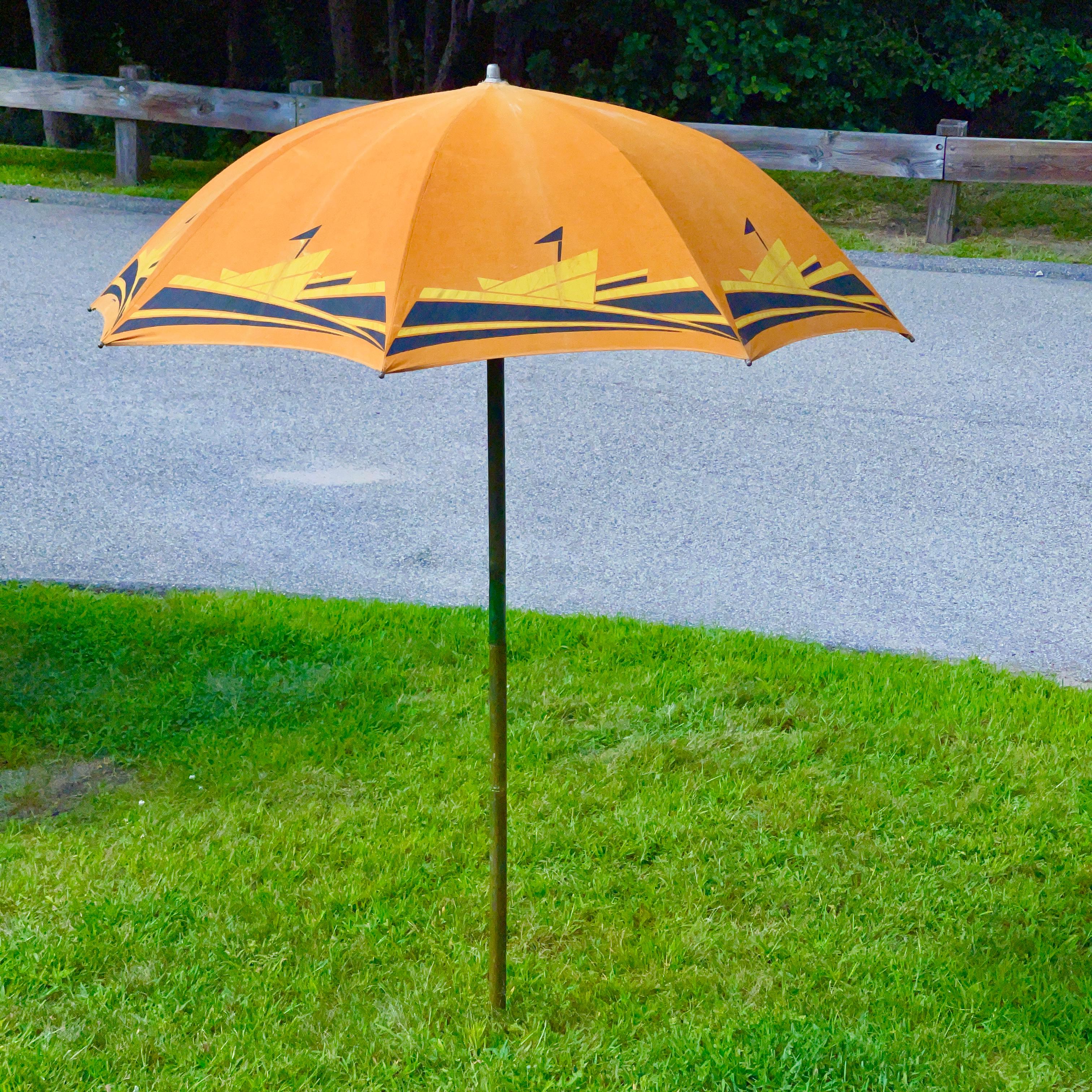 American Art Deco beach umbrella produced by the Troy Sunshade Co. circa 1936.
Highly stylized streamlined silkscreened graphic yellow and black ocean liners steaming through the waves against a brilliant orange sky. 
Cotton canvas duck on