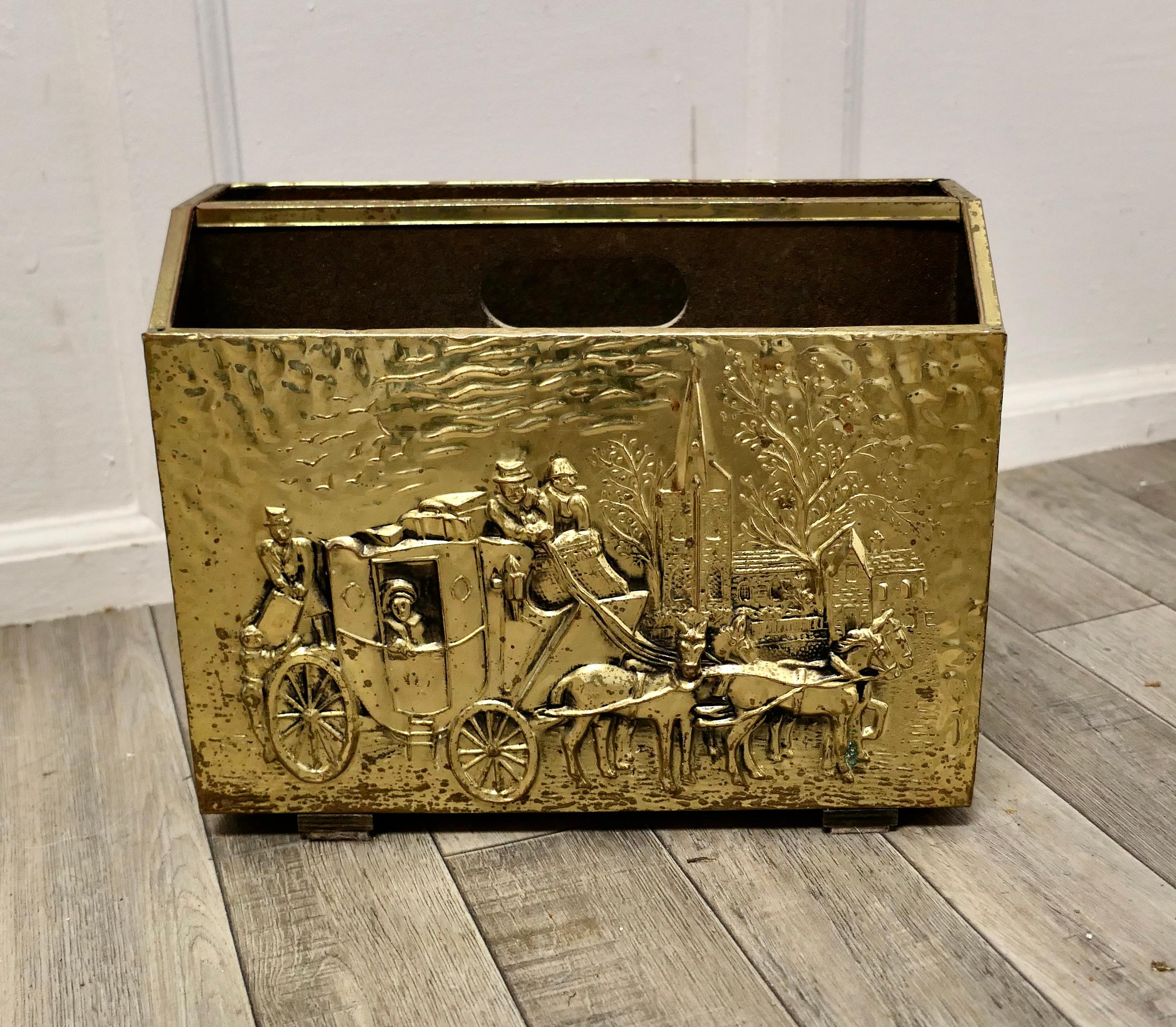 Art Deco beaten brass magazine rack.

This is a pretty little piece, in brass, it has 2 magazine sections, a carrying handle to the centre, the brass on the front shows a Stage Coach in winter
An excellent and good looking piece, it is in good